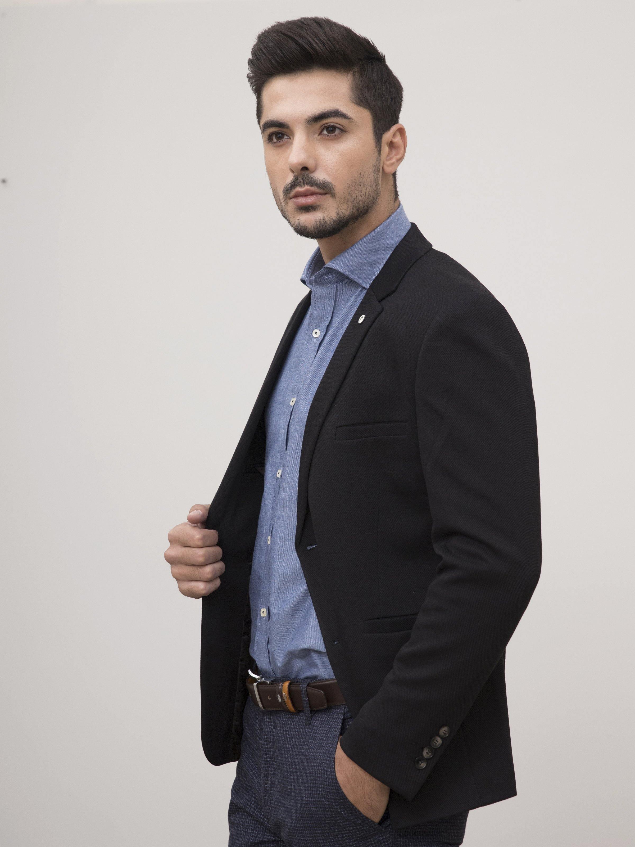 Black slim-fit coat detail with button front, welt pocket, and notch lapels