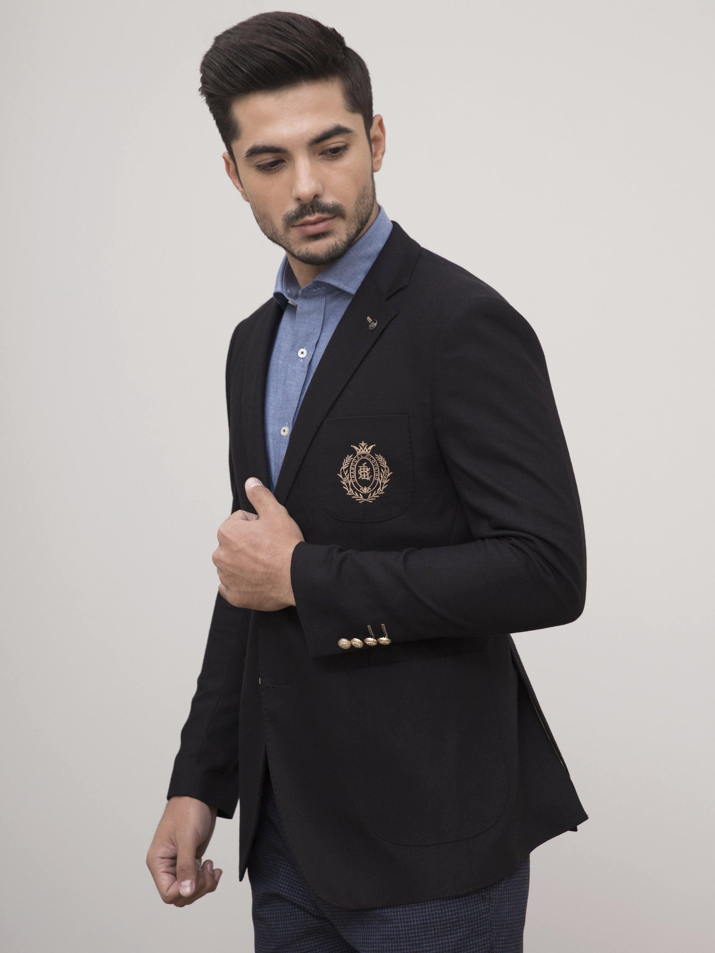 Black slim-fit coat with gold cuff buttons and embroidered crest badge.