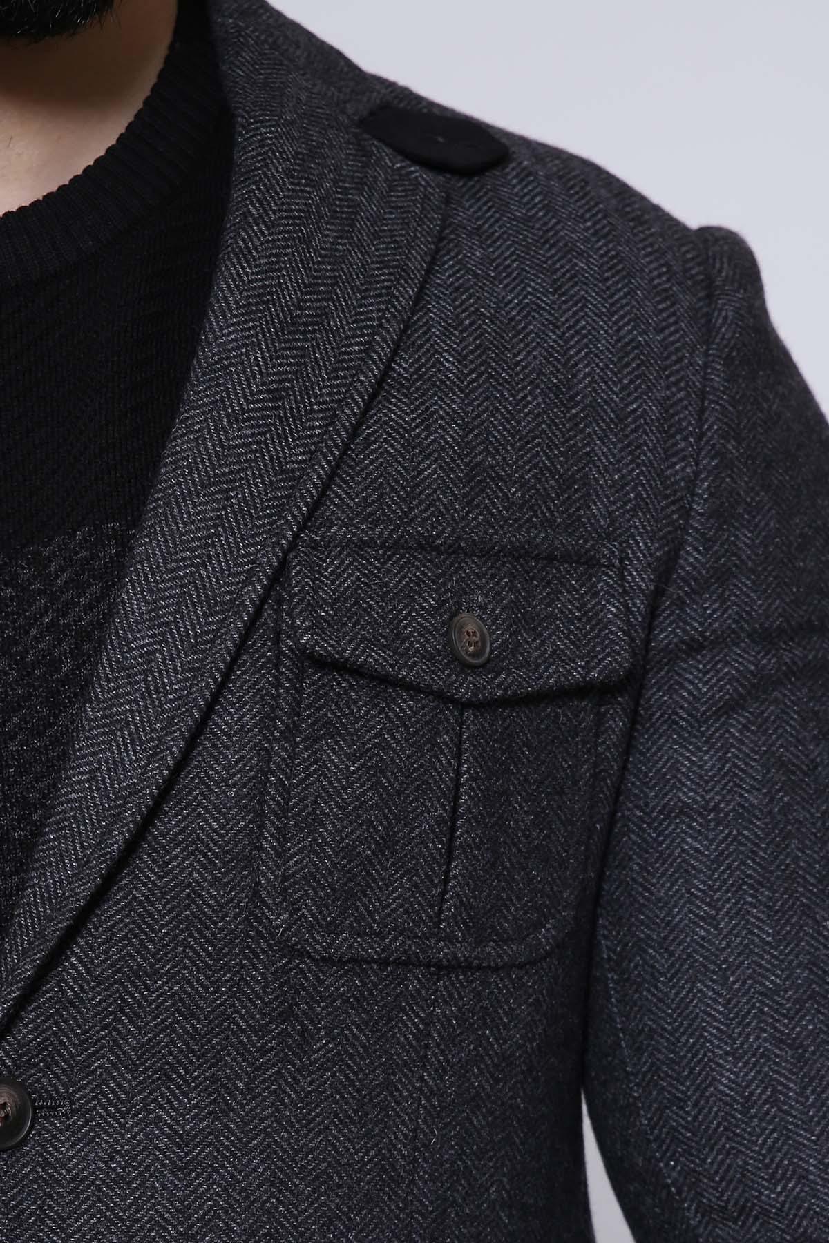 Charcoal tweed-style coat with flap chest pockets and subtle herringbone texture