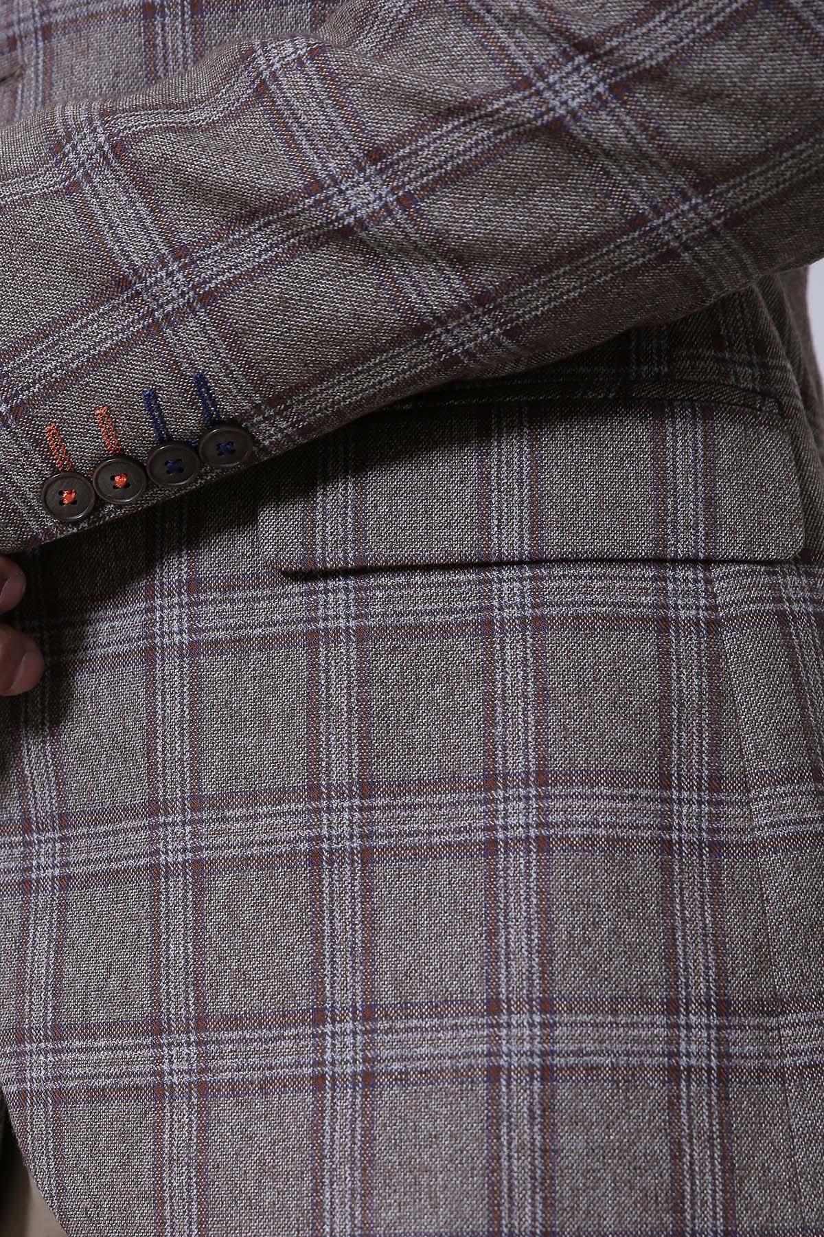 Plaid slim-fit coat detail: buttoned cuff and front pocket seam.