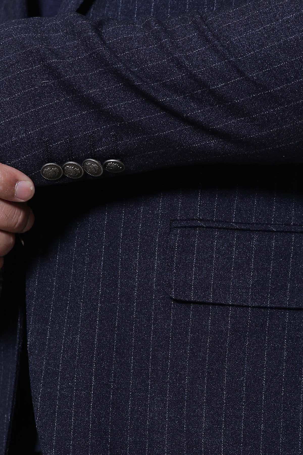 Navy pinstripe coat detail with buttoned front and flap chest pocket