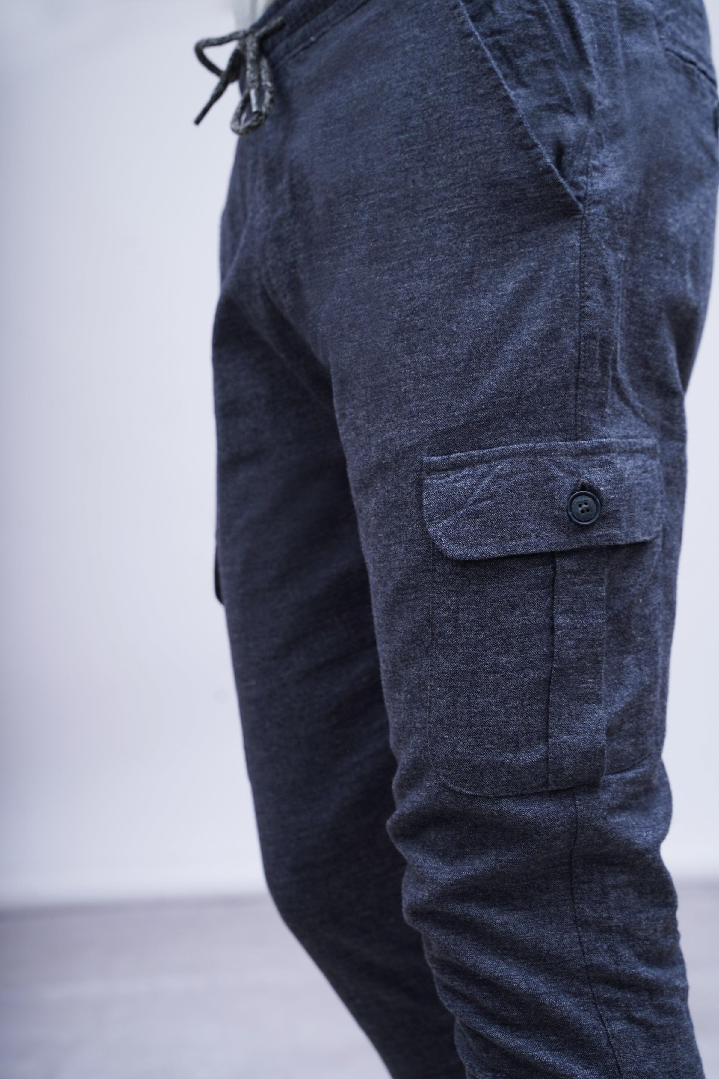 Dark blue-grey jogger trousers detail: drawstring ties and thigh cargo pocket
