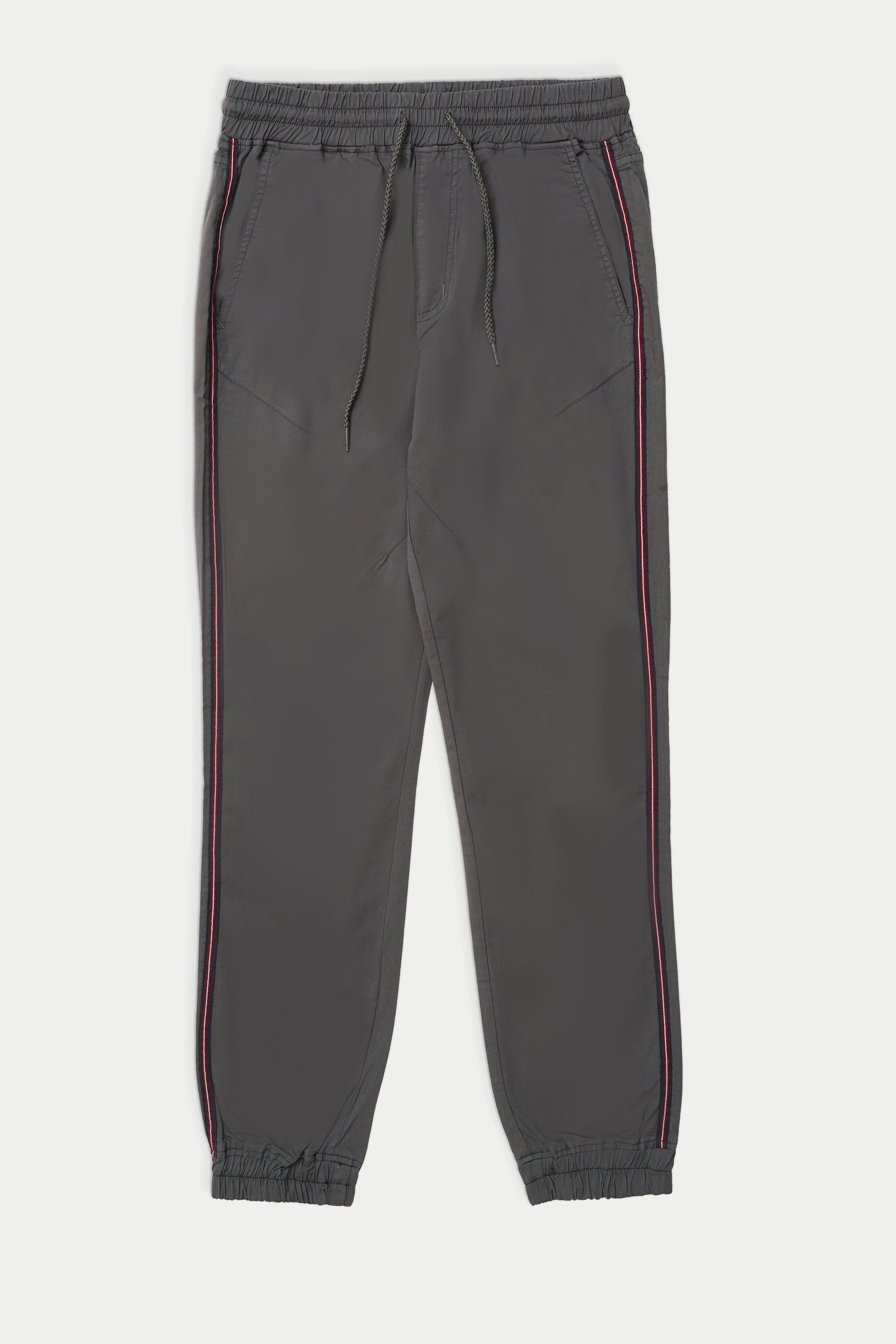 Grey casual jogger trousers with drawstring waist and elastic cuffs, side stripe