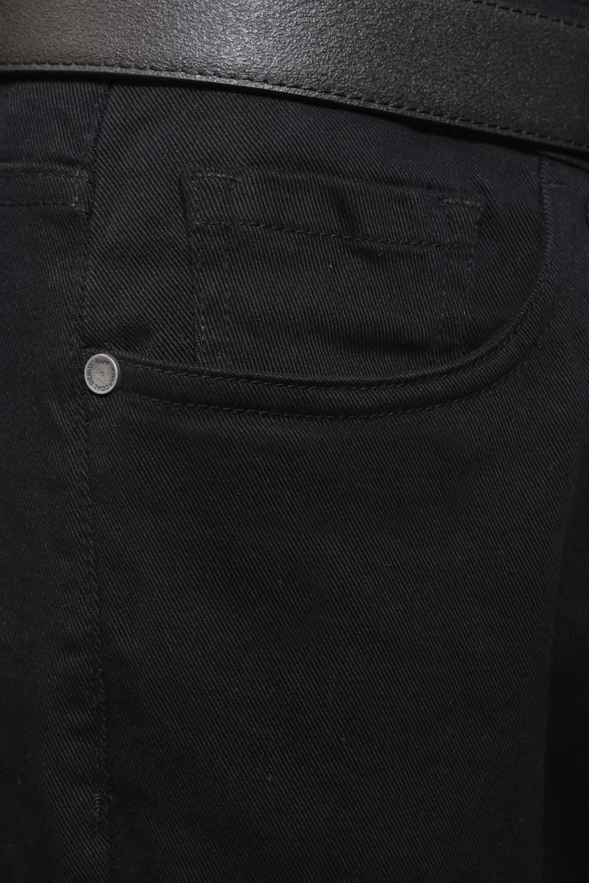 Black casual pants coin pocket detail with curved pocket seam and metal rivet