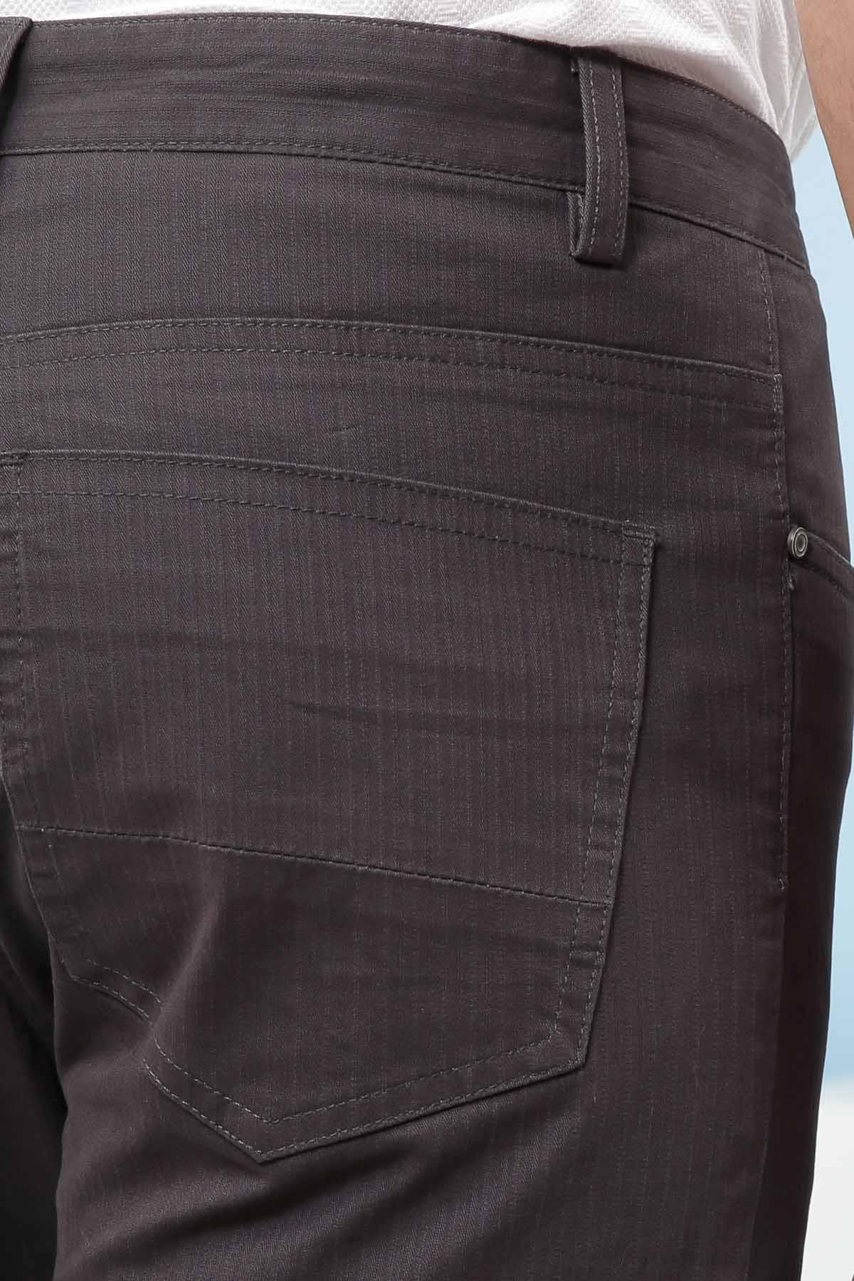 Dark grey pants close-up: front pocket and waistband with belt loop.