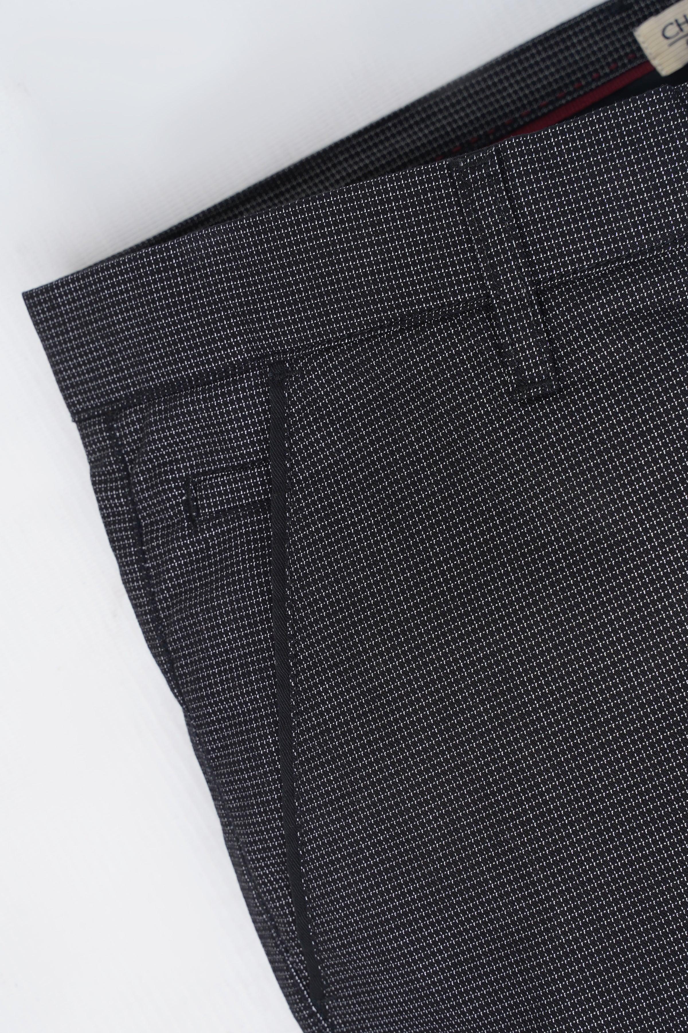 Dark textured casual pants fabric close-up with visible seam and stitching
