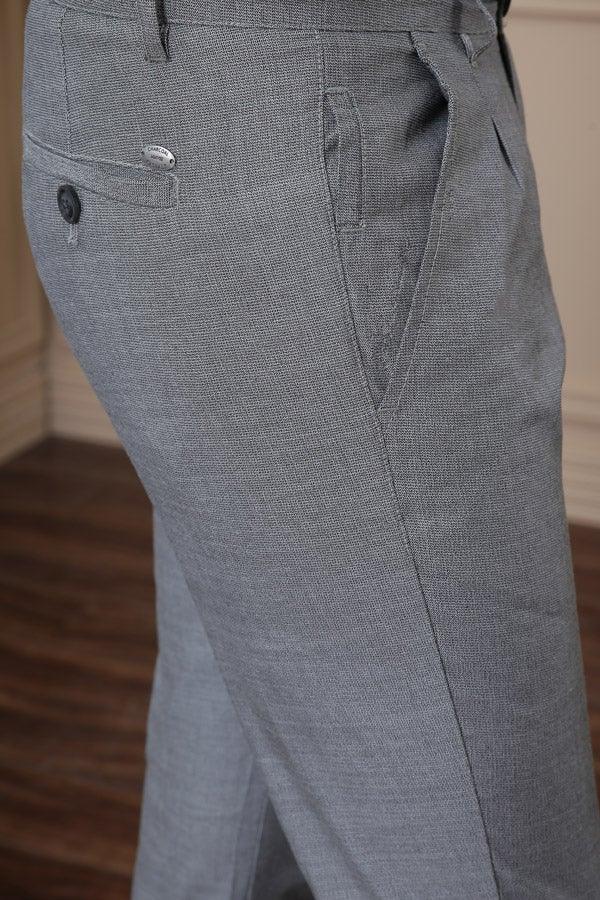 Men's casual pants close-up: light blue-gray cross pocket, seam details, button