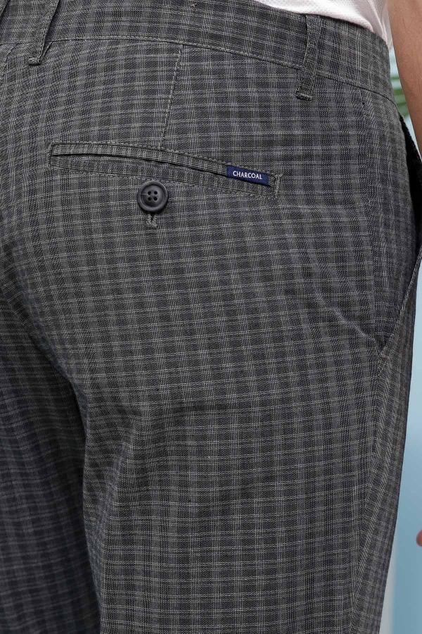 Dark gray check slim-fit pants with buttoned front pocket and logo label