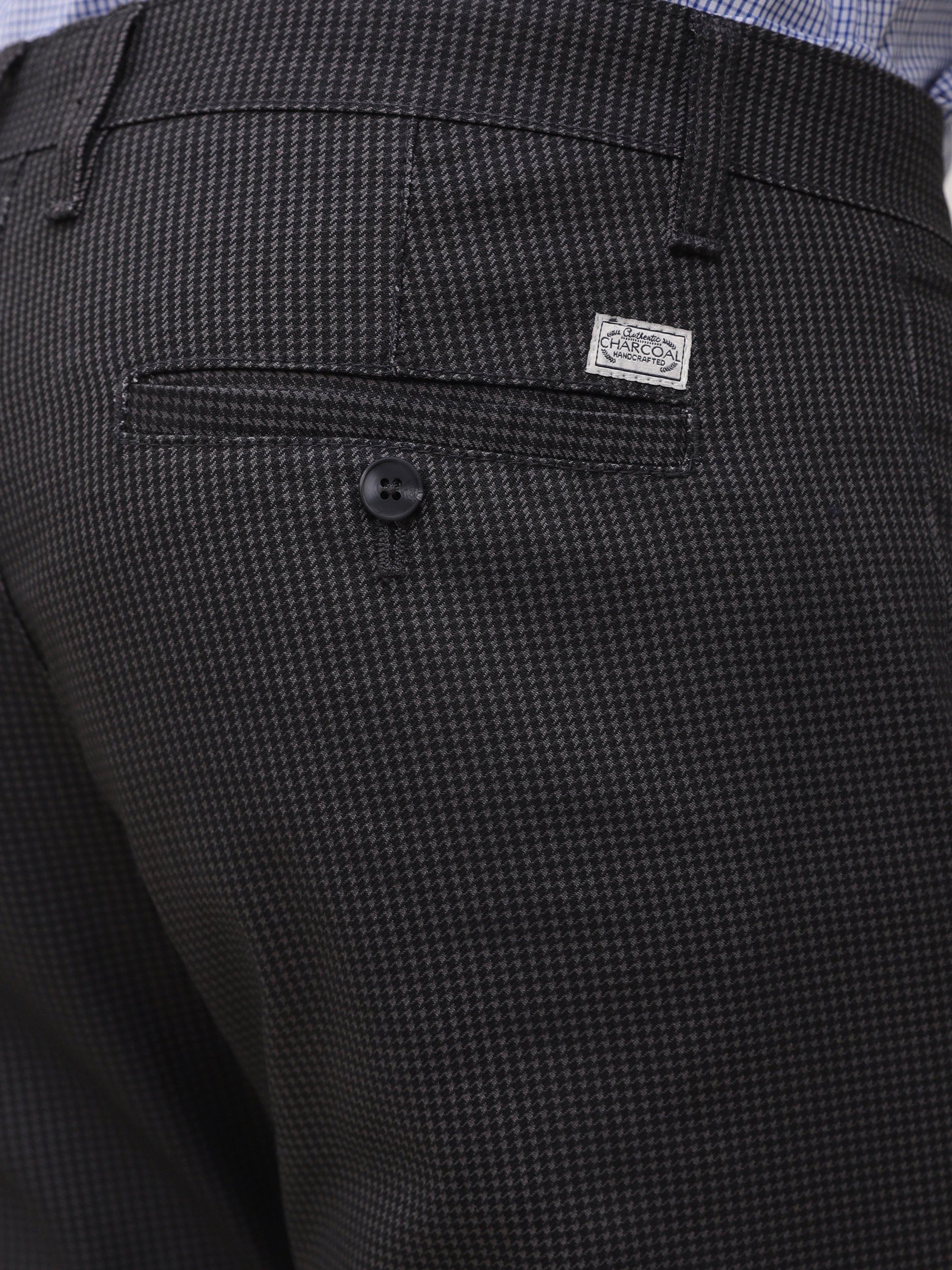 Black houndstooth pants waistband with brand patch and button