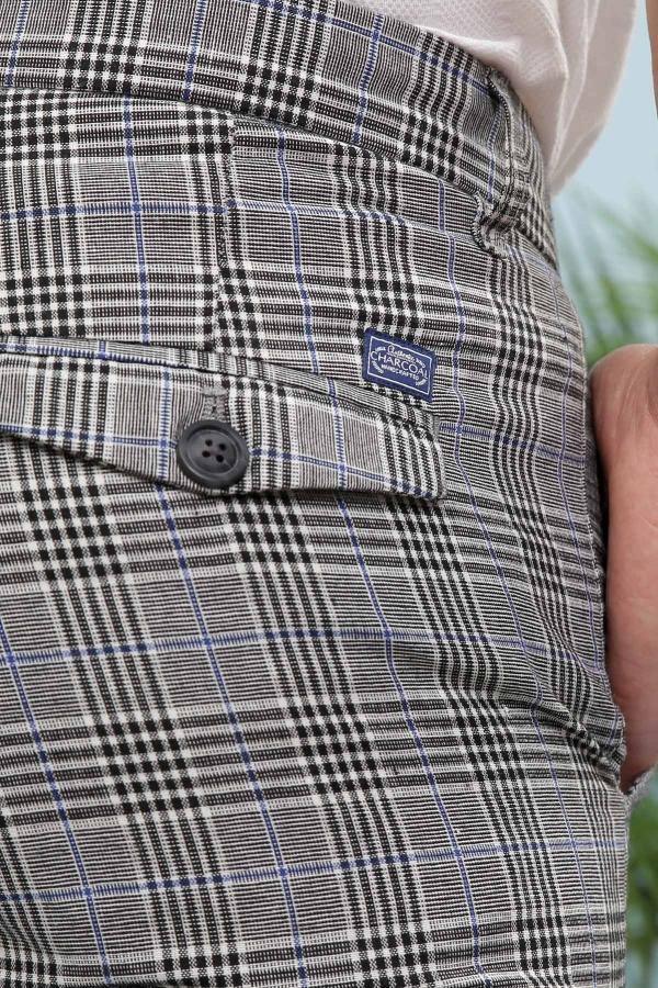 Plaid slim pants waist close-up with button fly and stitched logo patch
