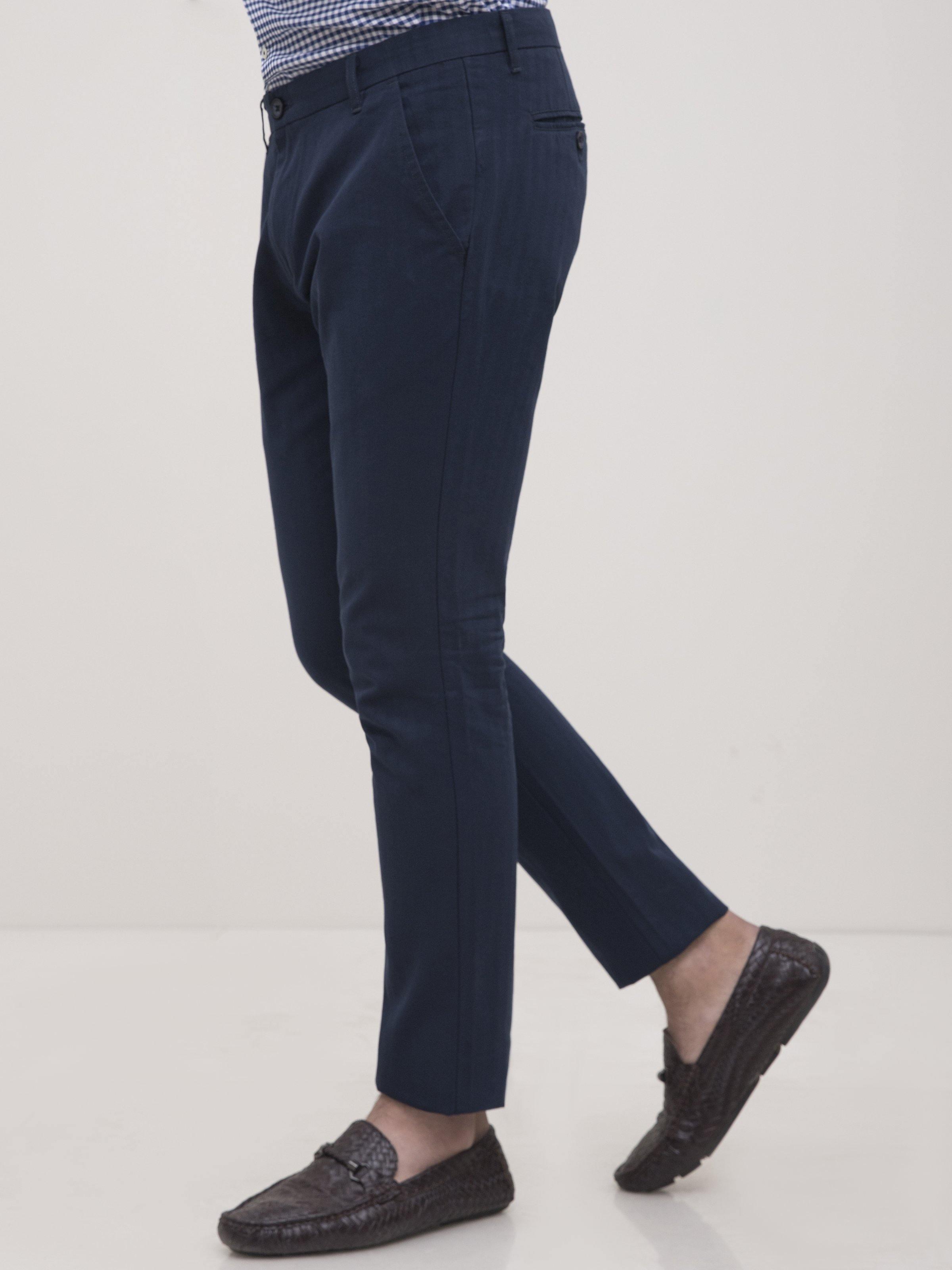 Navy slim-fit casual pants with cross pockets and tapered leg