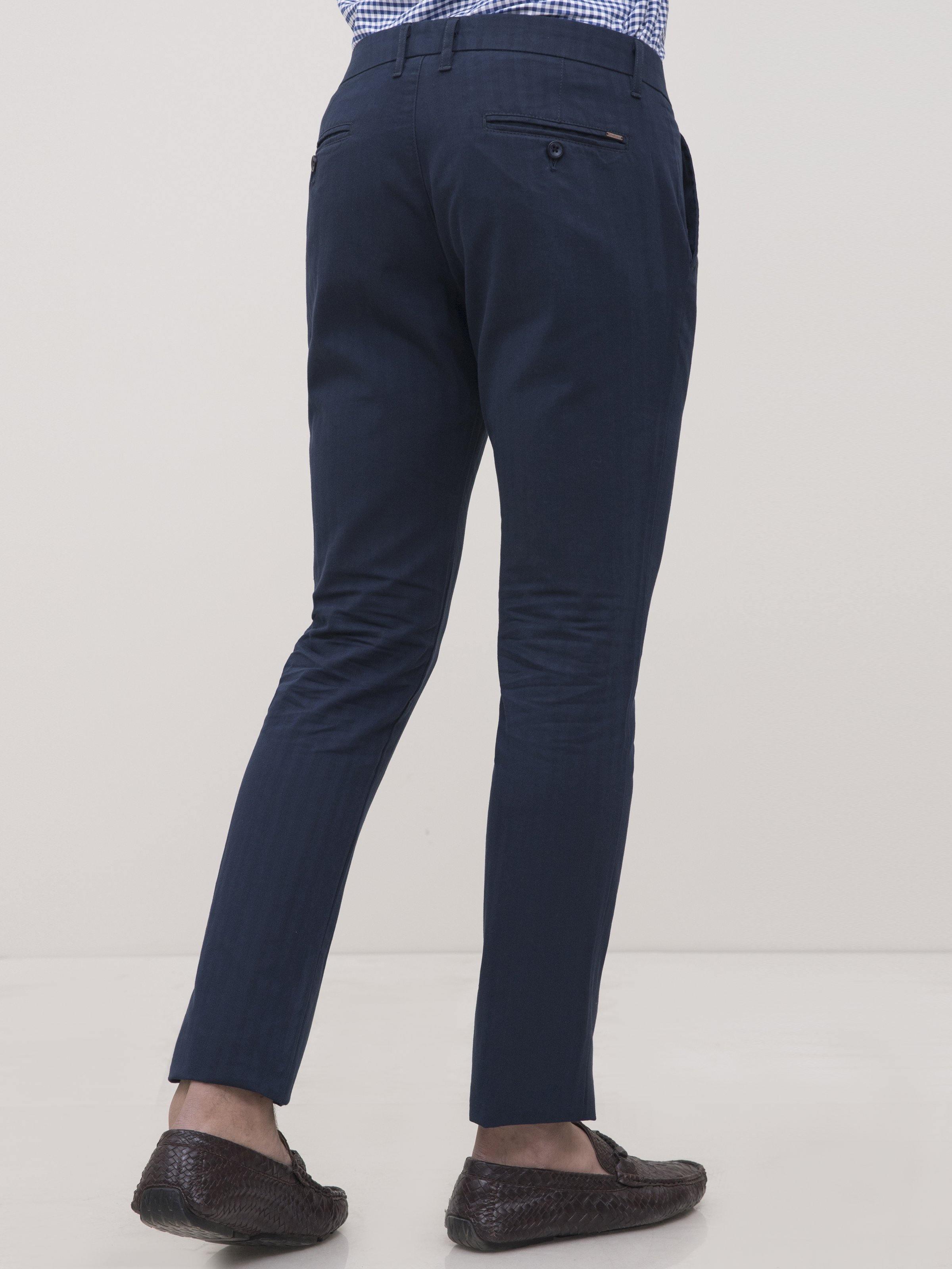Navy slim-fit casual pants side view with tapered hem and front seam details