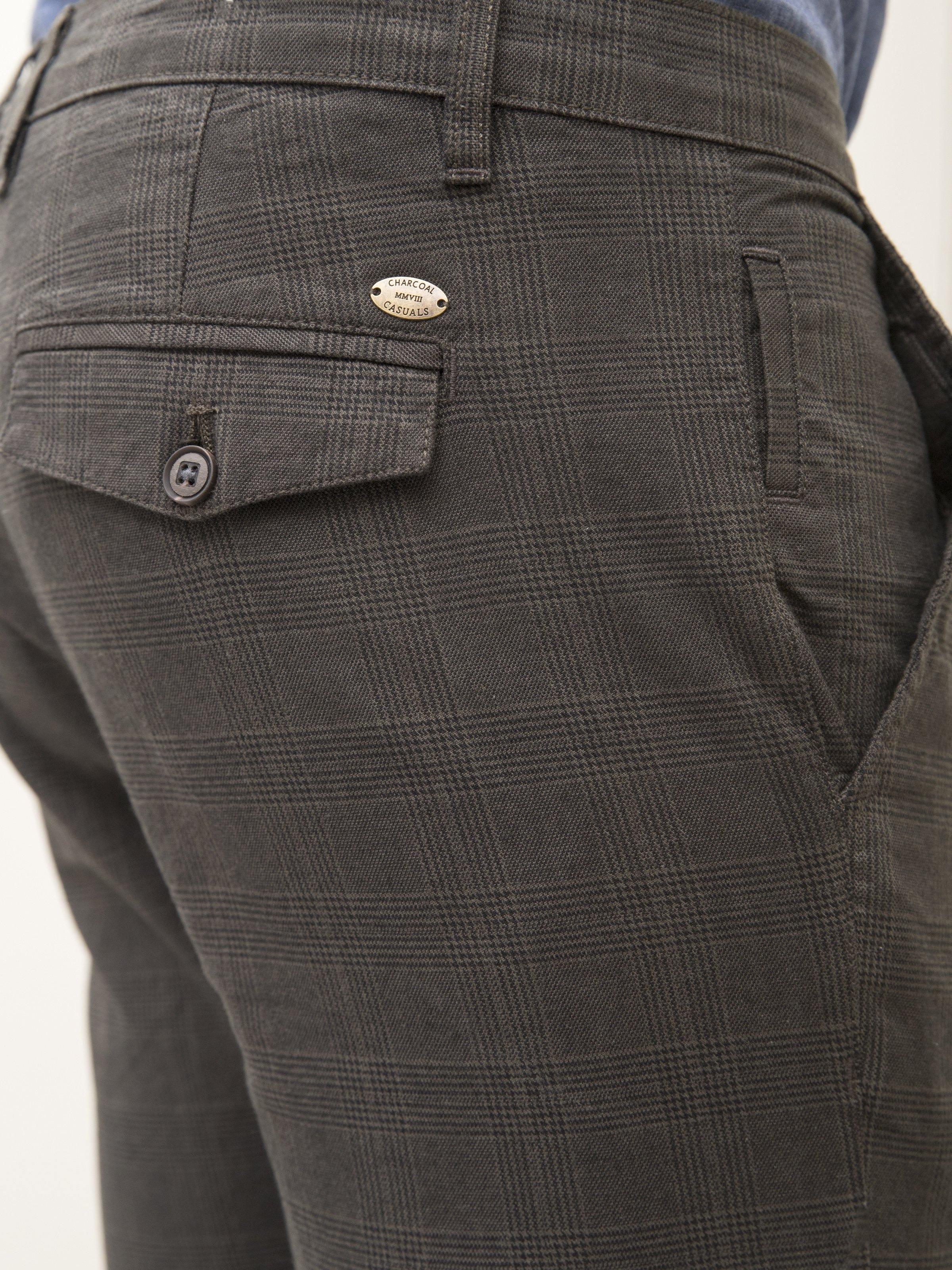 Dark olive casual pants close-up of flap pocket and button details