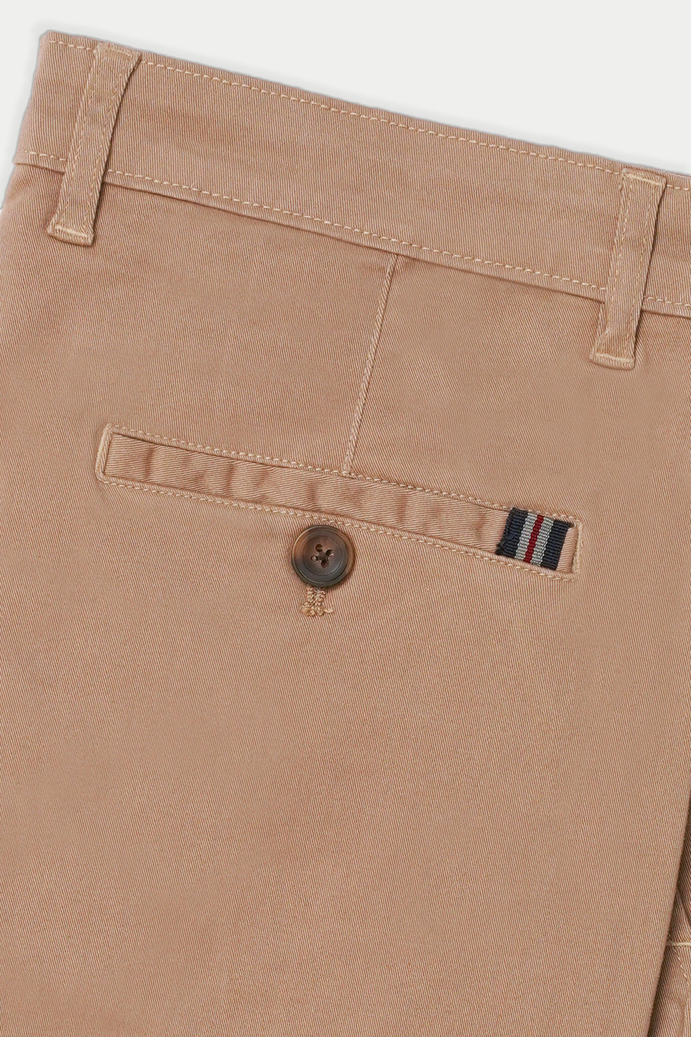 Light brown casual pants front pocket detail with contrast stitch and button.