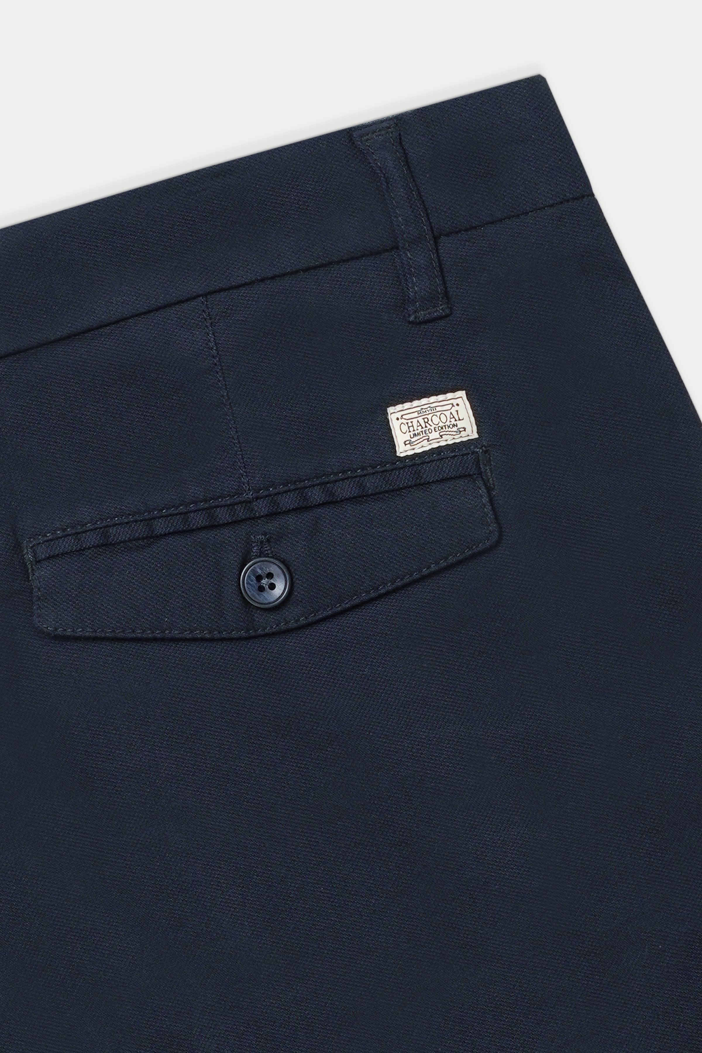 Navy casual pants close-up: button fly and coin pocket with logo patch