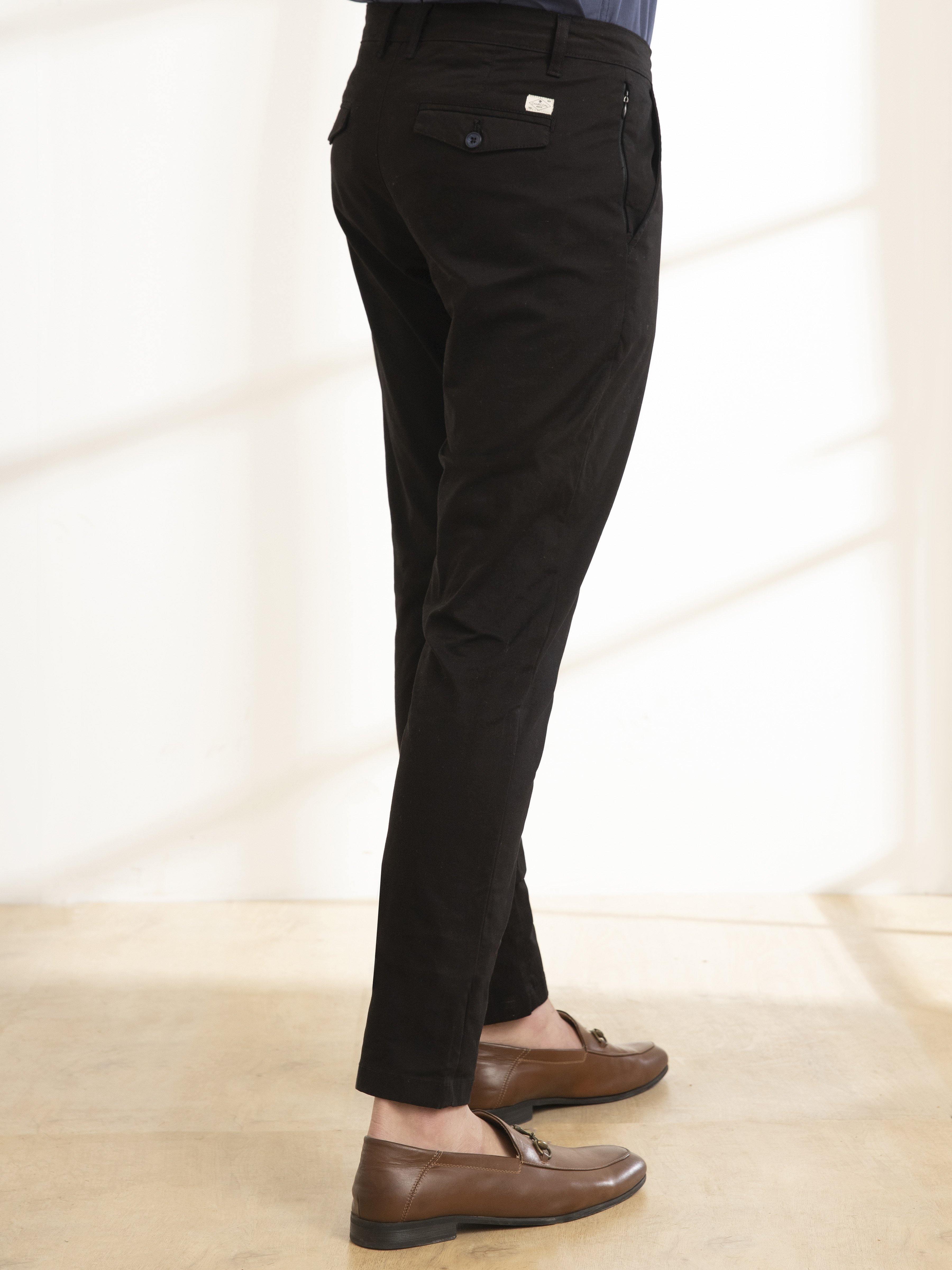 Slim-fit black casual pants with back pocket detail and tapered leg