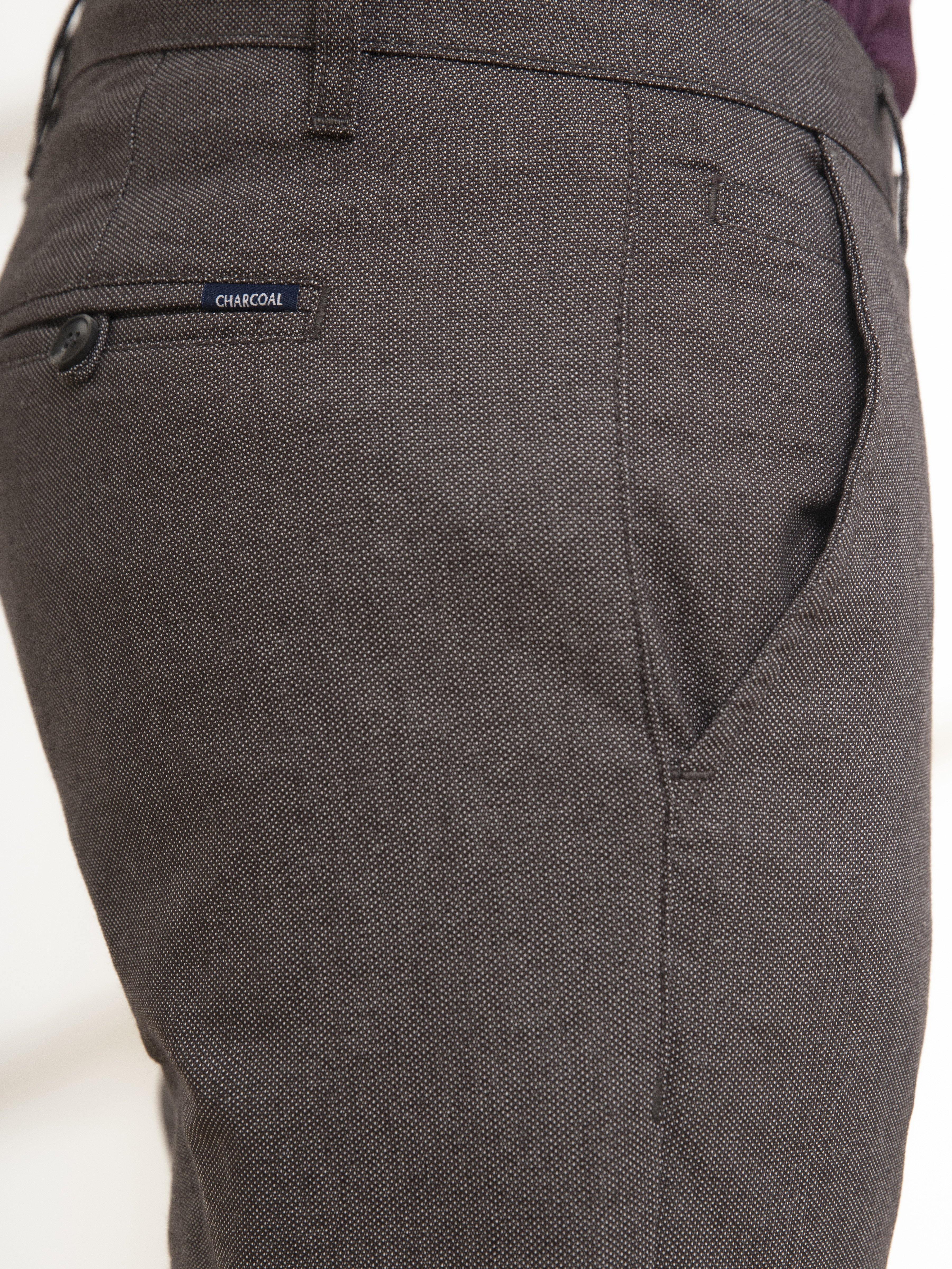 Charcoal casual pants close-up: curved side pocket and stitched hem