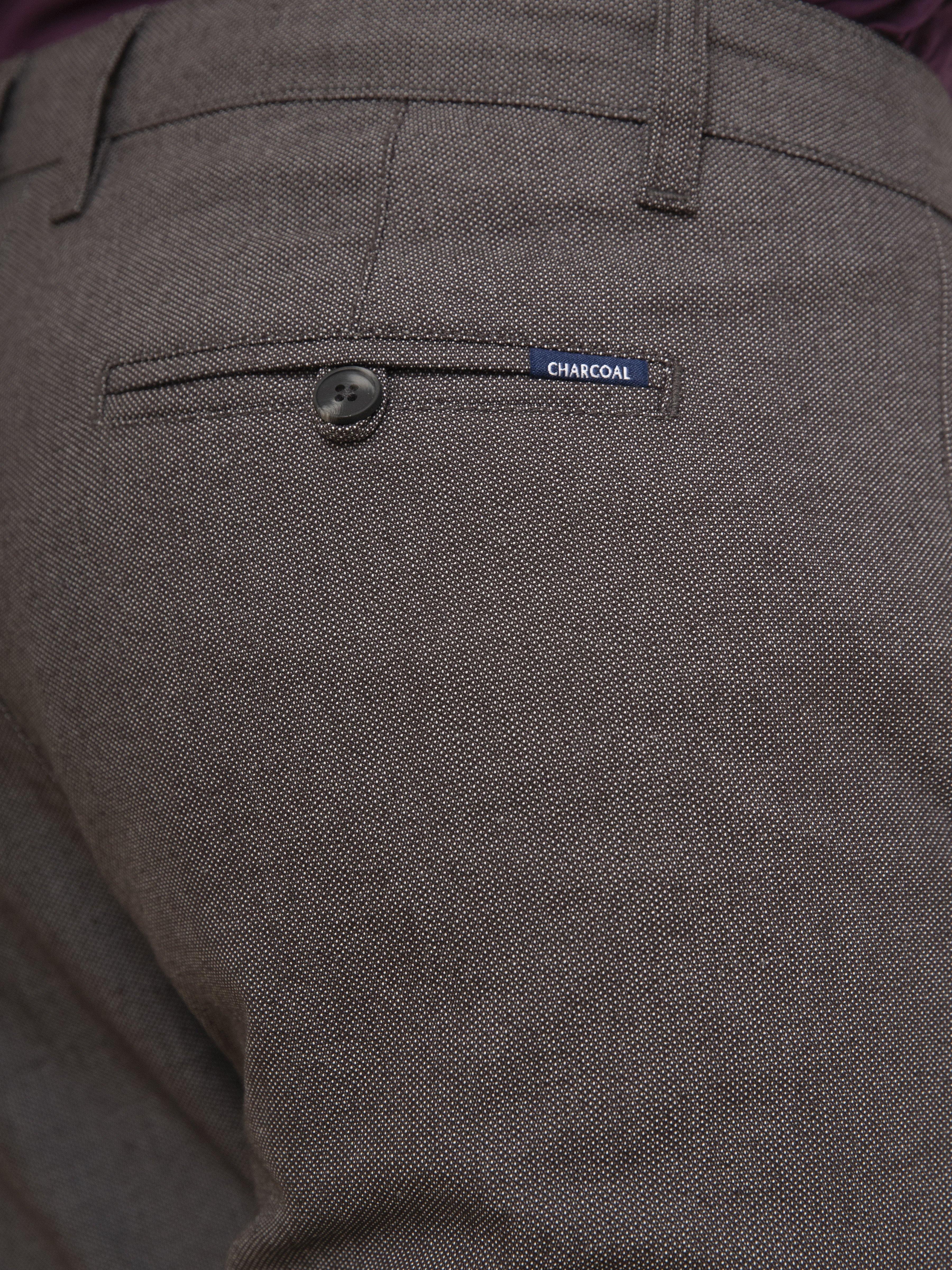 Charcoal casual pants close-up: button closure and slanted front pocket
