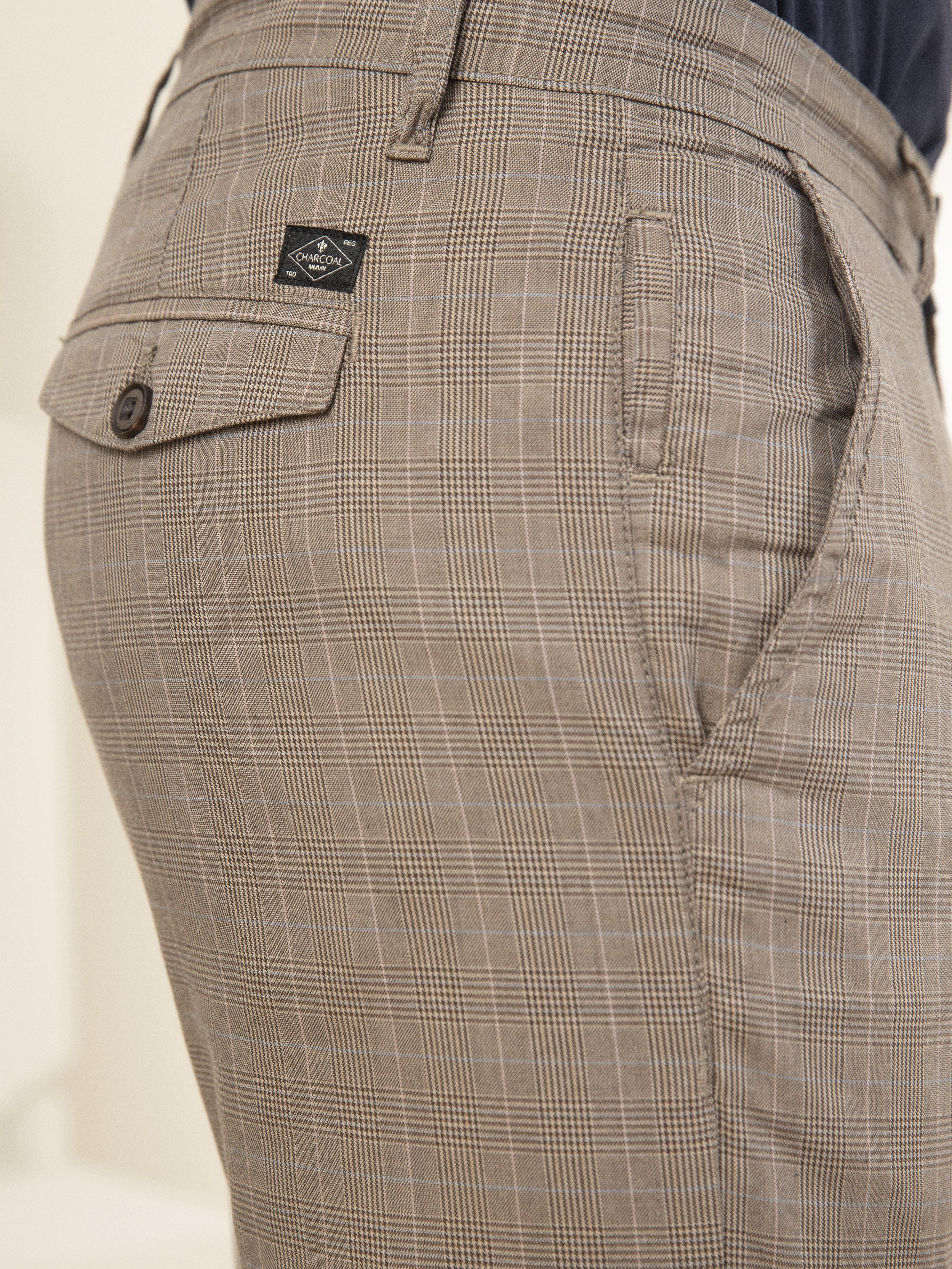 Slim-fit casual pants close-up: plaid weave, button tab on side pocket