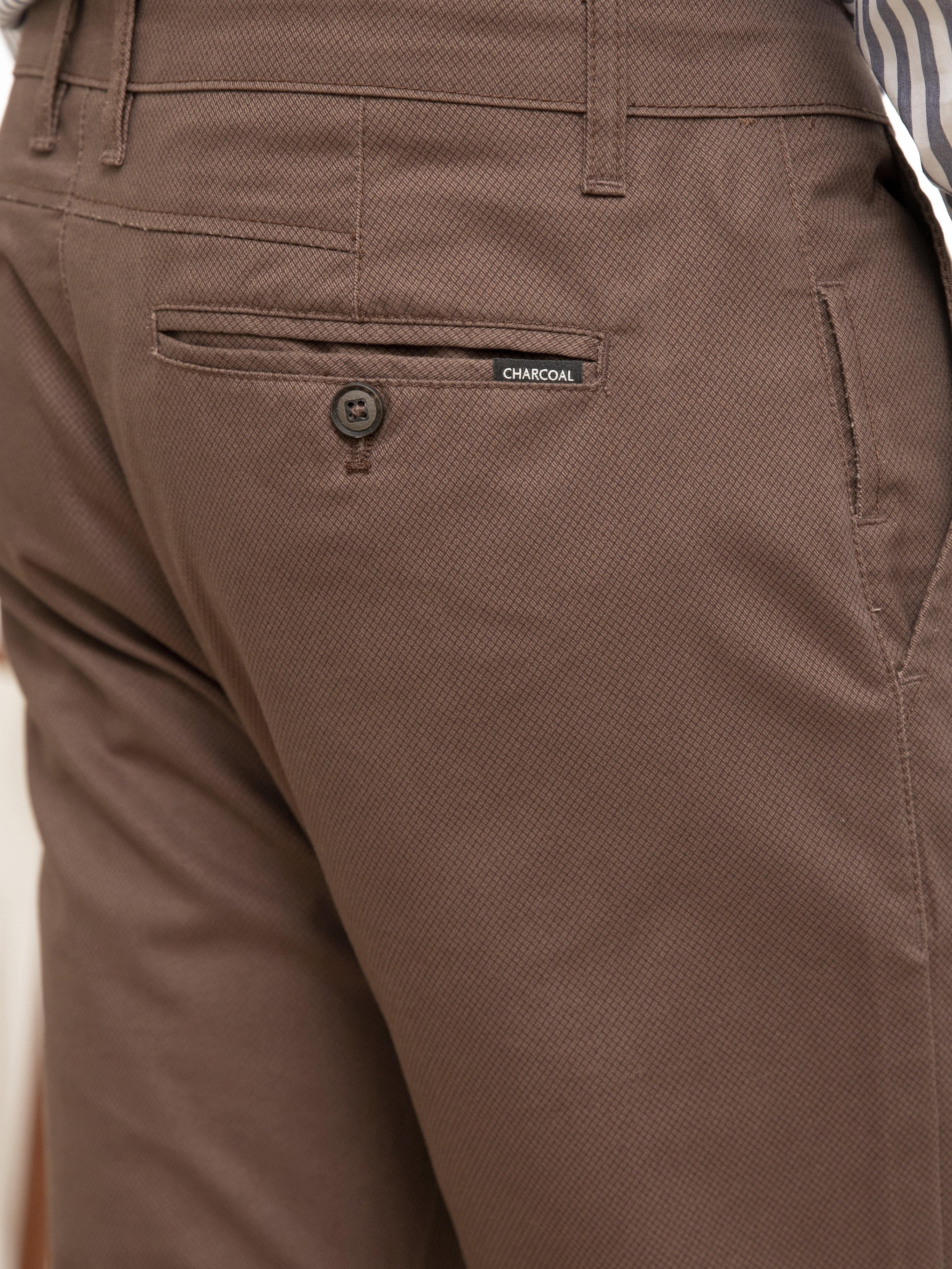 Dark brown pants close-up of front pocket and waistband label