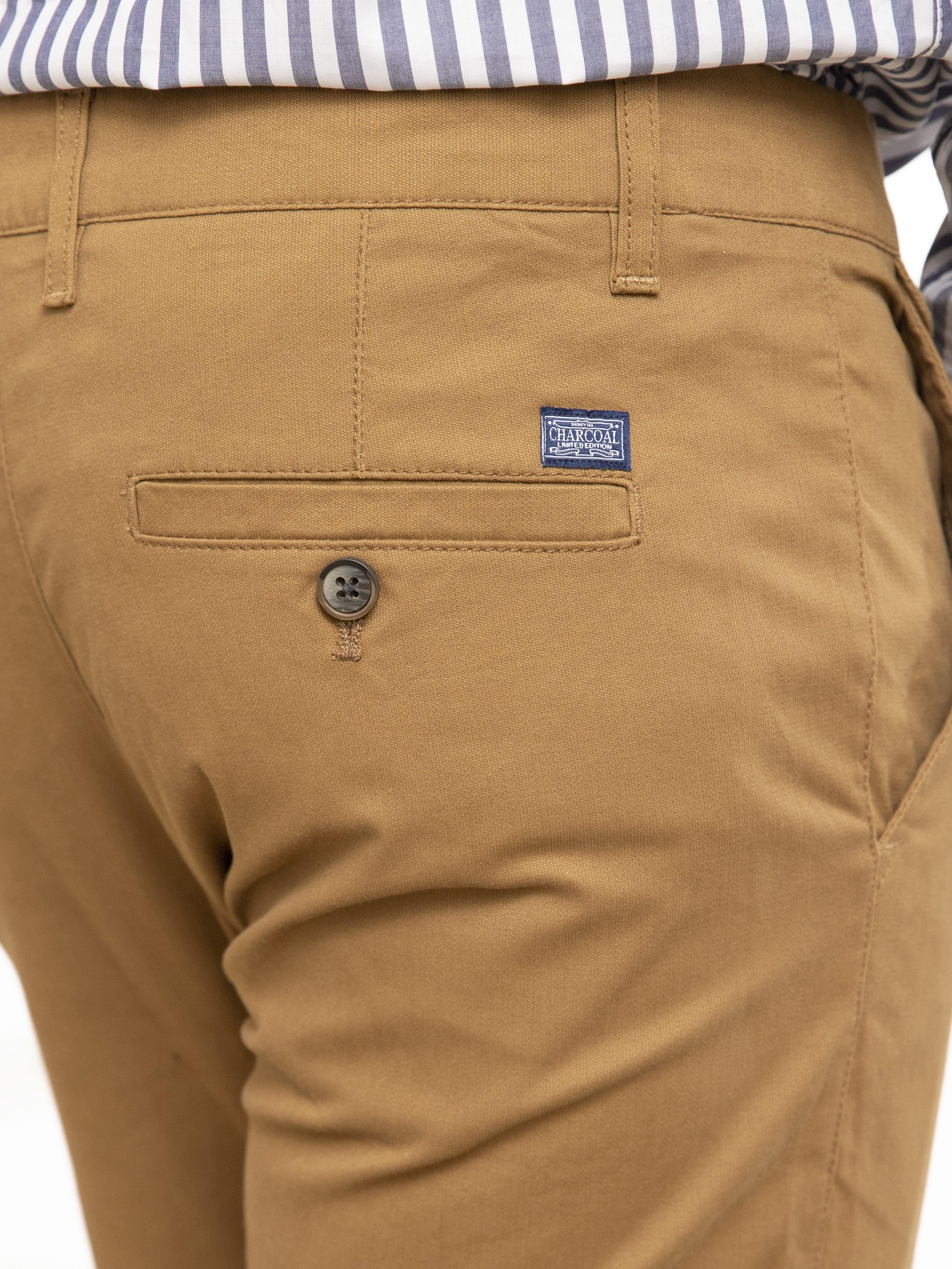 Camel slim-fit pants close-up of coin pocket with brand patch