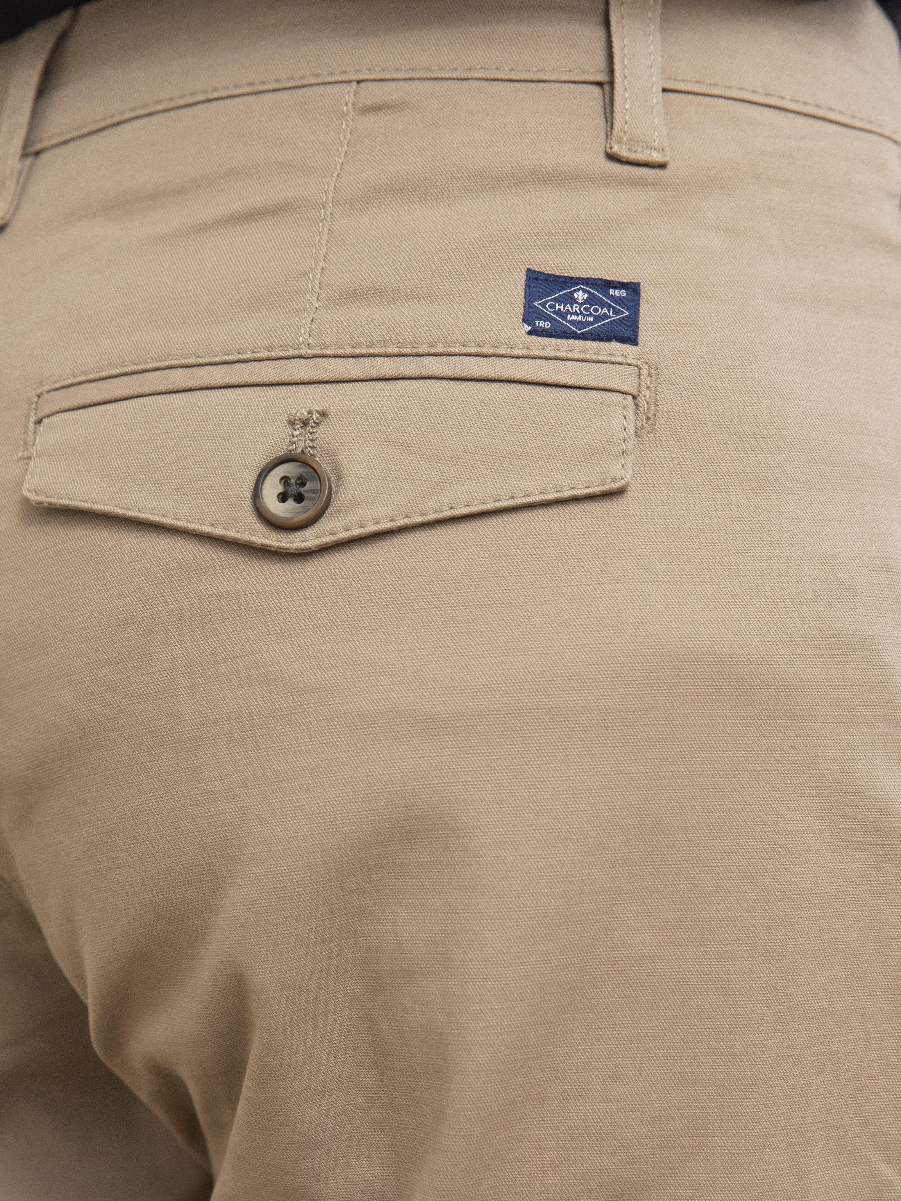 Casual pants fabric closeup with button and embroidered waistband label
