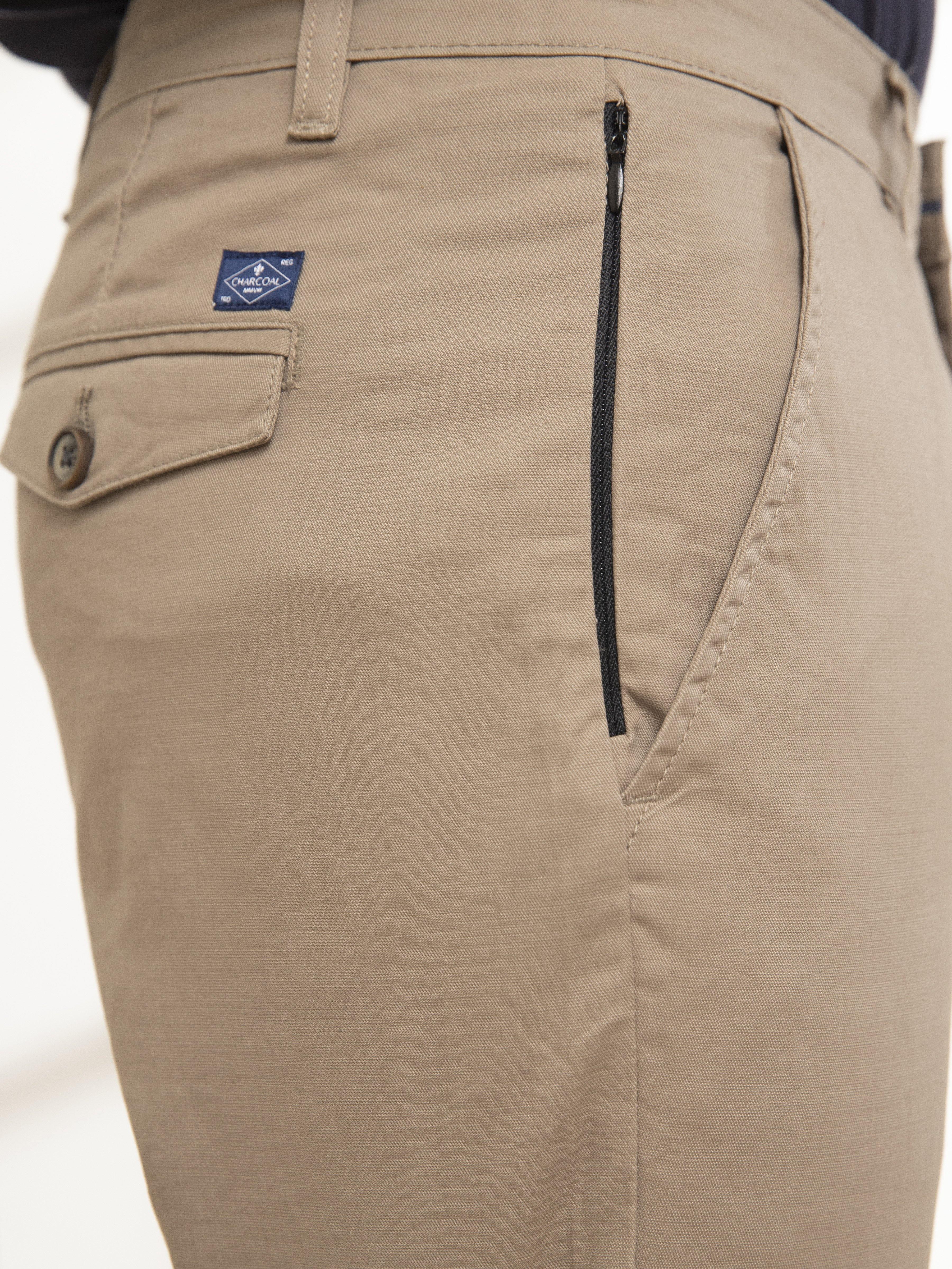 Casual pants back pocket detail with zip fly and logo patch