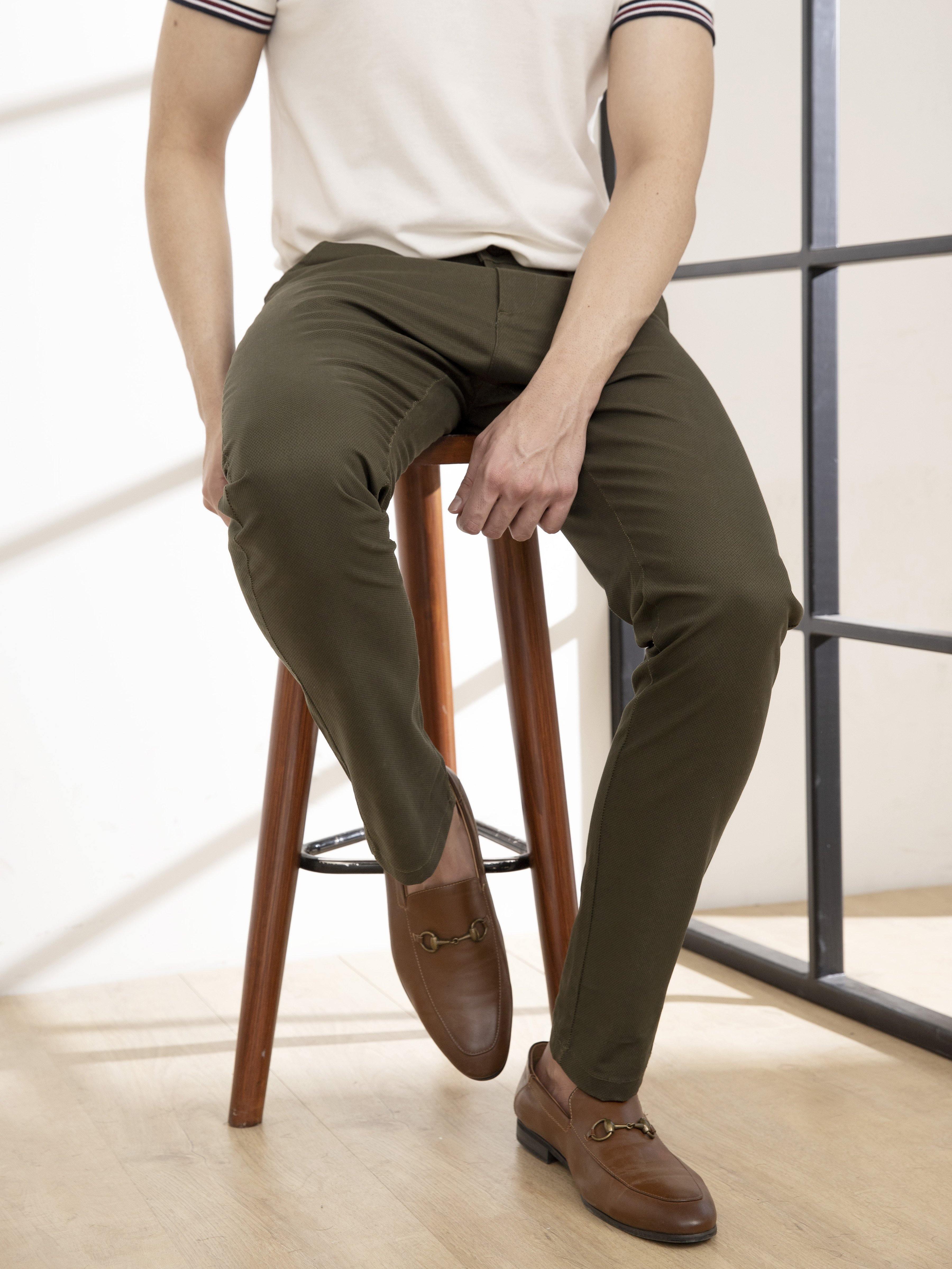 Olive slim-fit casual pants, side view with tapered leg and cuffed hem