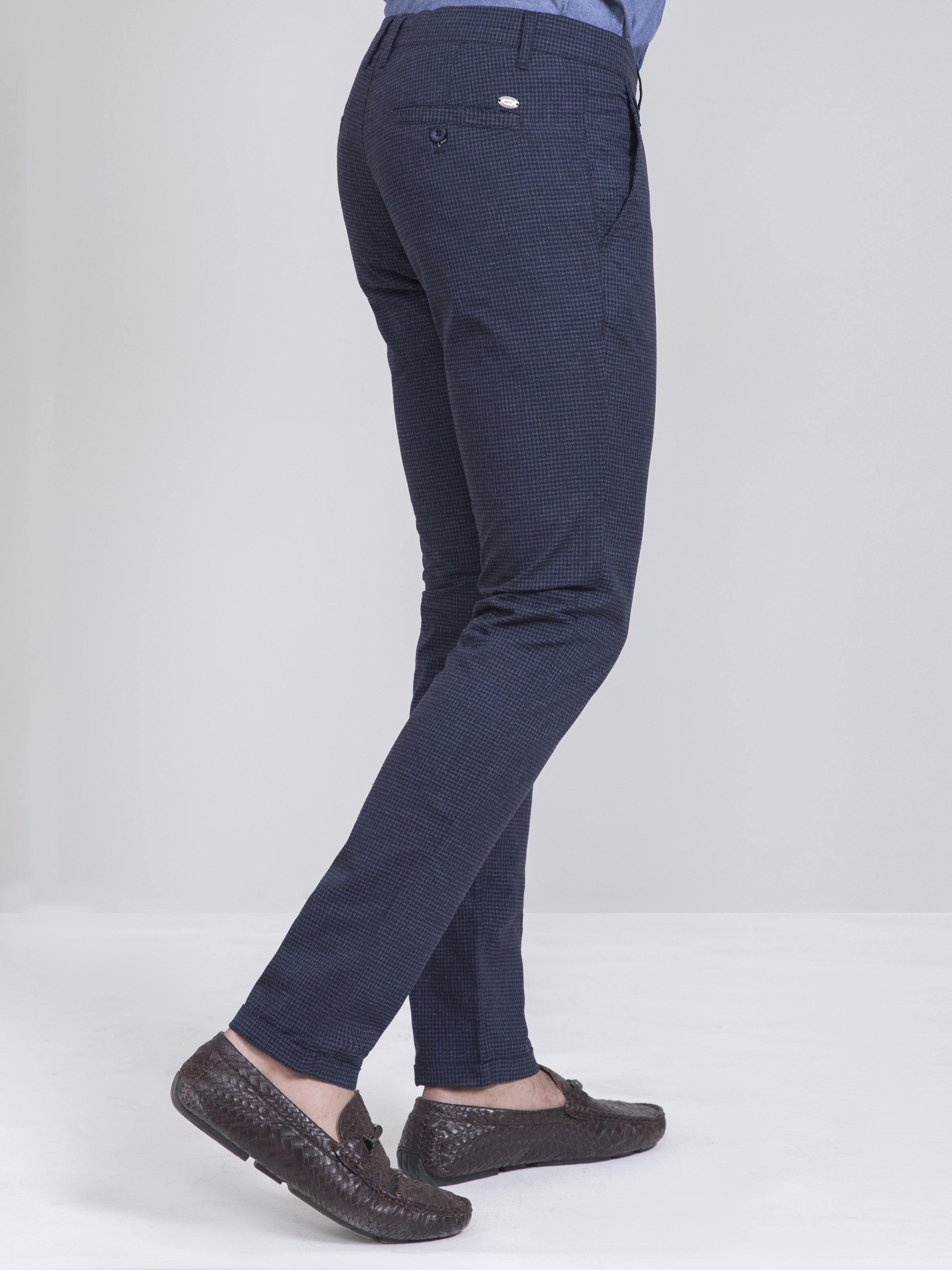 Slim-fit casual pants in dark navy check, angled side view with back pocket detail