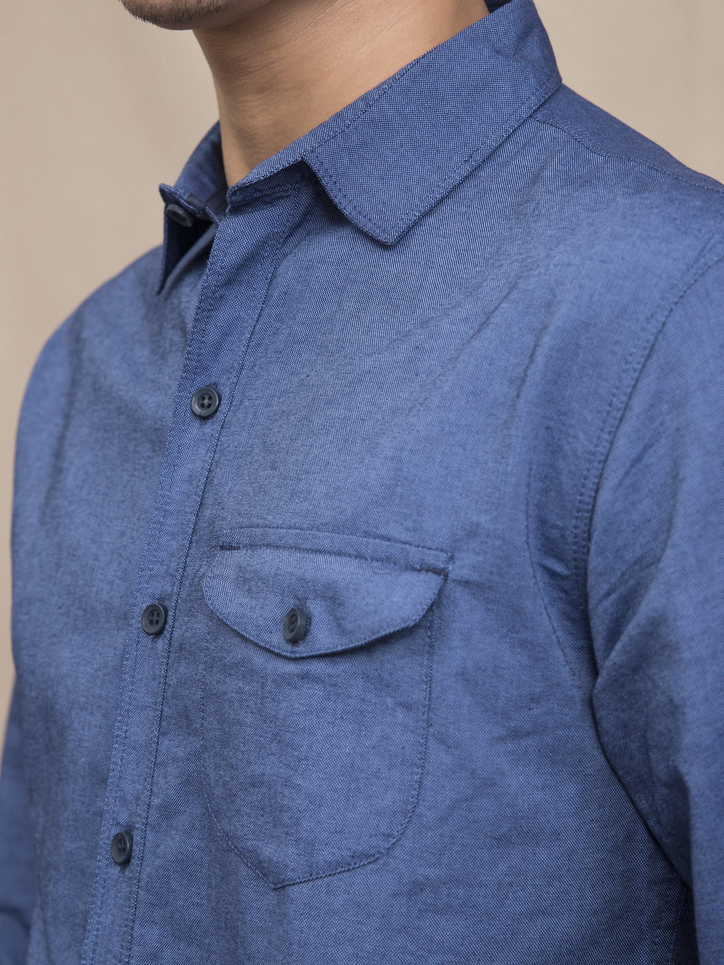 Blue casual shirt with pointed collar, button front, and chest pocket detail