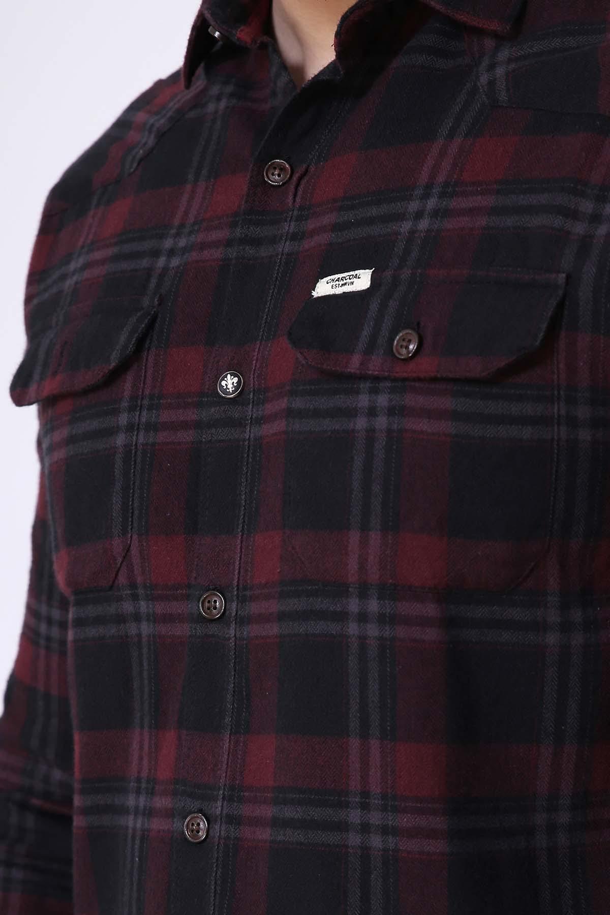 Casual shirt chest detail, dark plaid with flap pocket, buttons, and logo tag