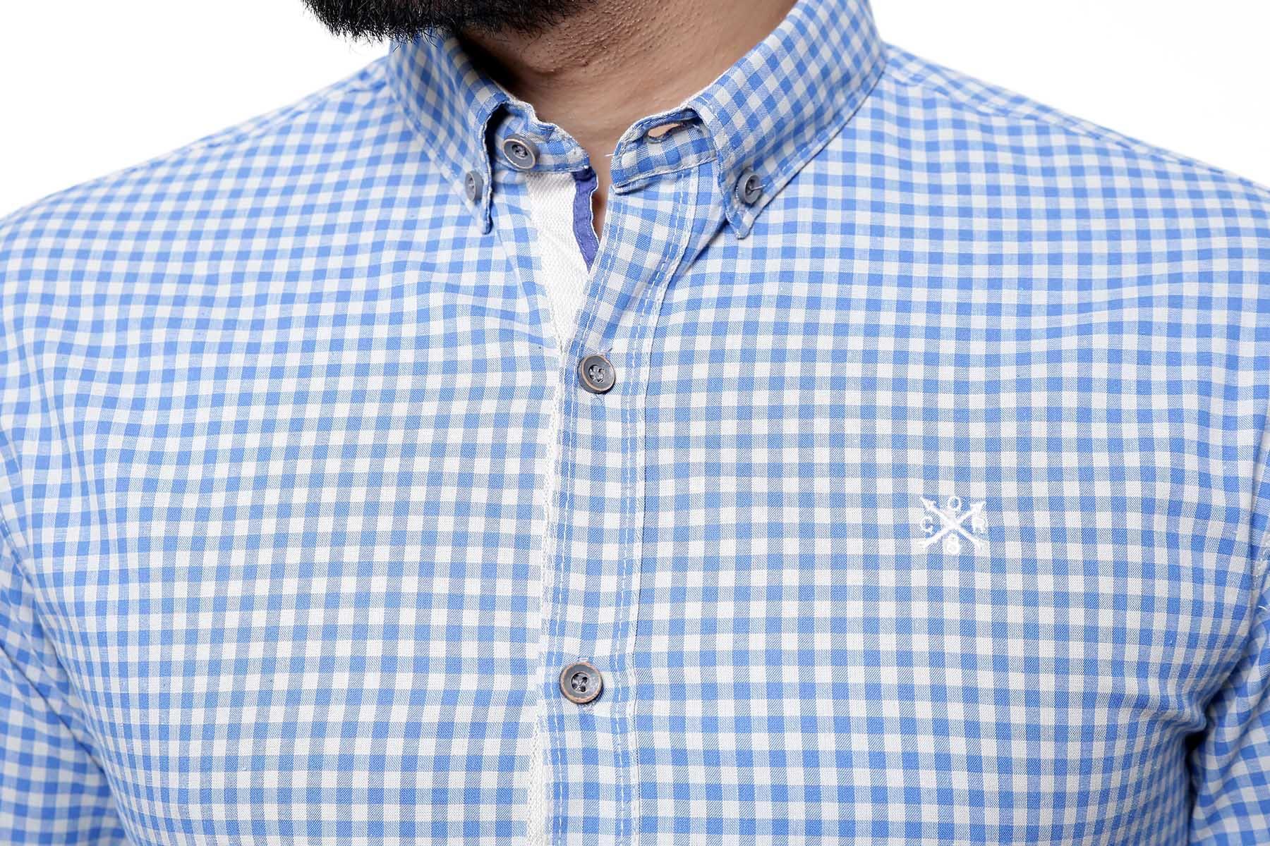 Blue-grey check button-down shirt close-up, logo on chest, button placket