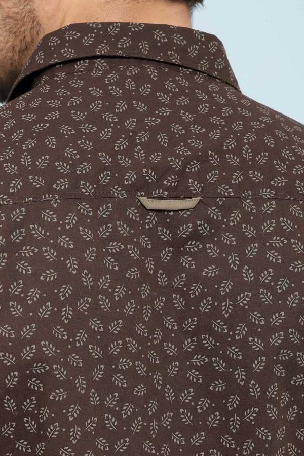 Brown patterned shirt fabric close-up with collar and center seam