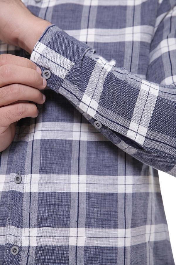 Grey plaid shirt cuff with buttoned sleeve placket