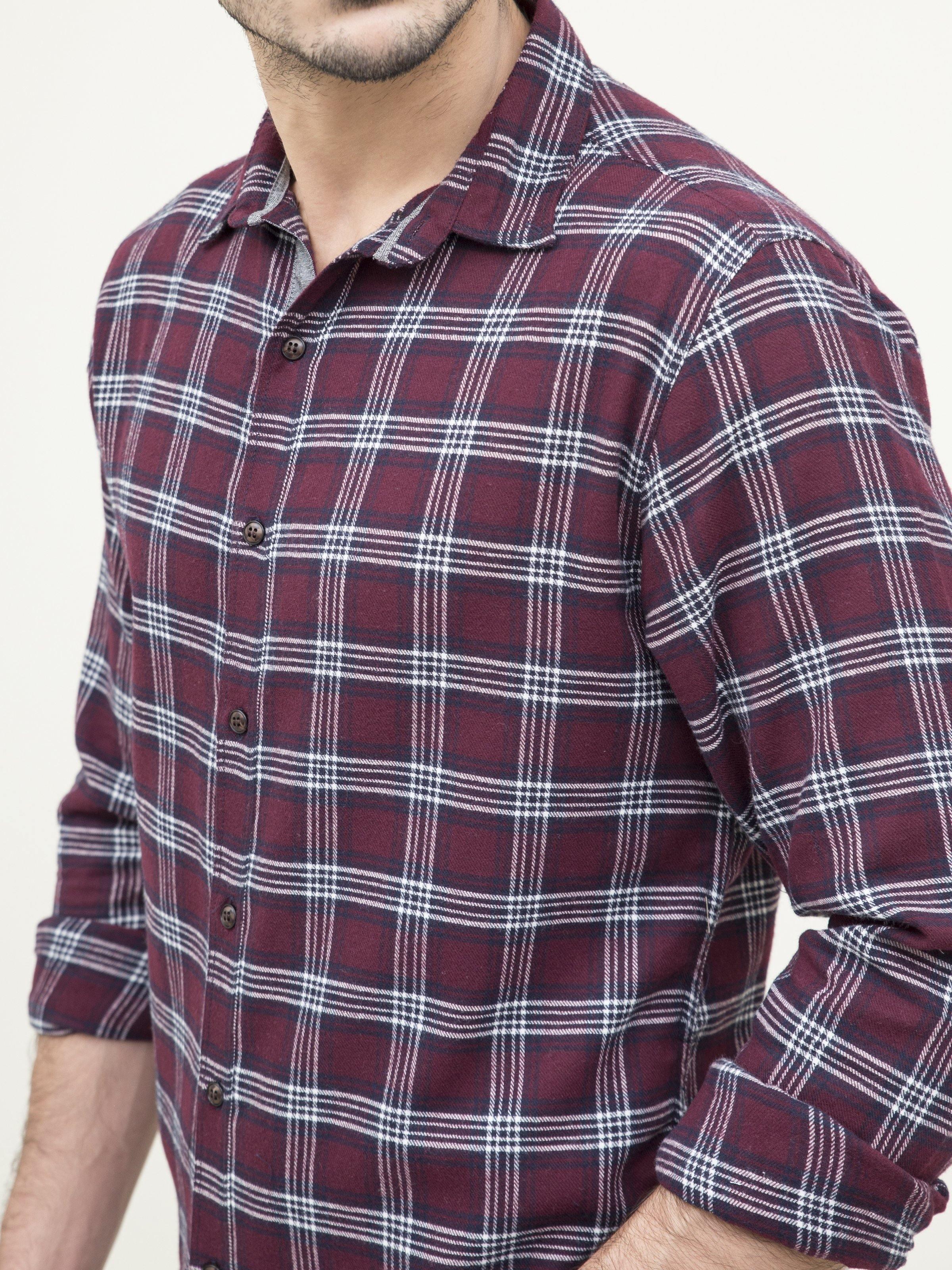 Maroon plaid shirt close-up with buttoned collar and cuffs