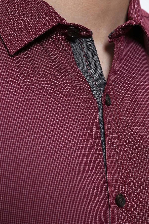 Maroon shirt close-up with pointed collar and dark button placket