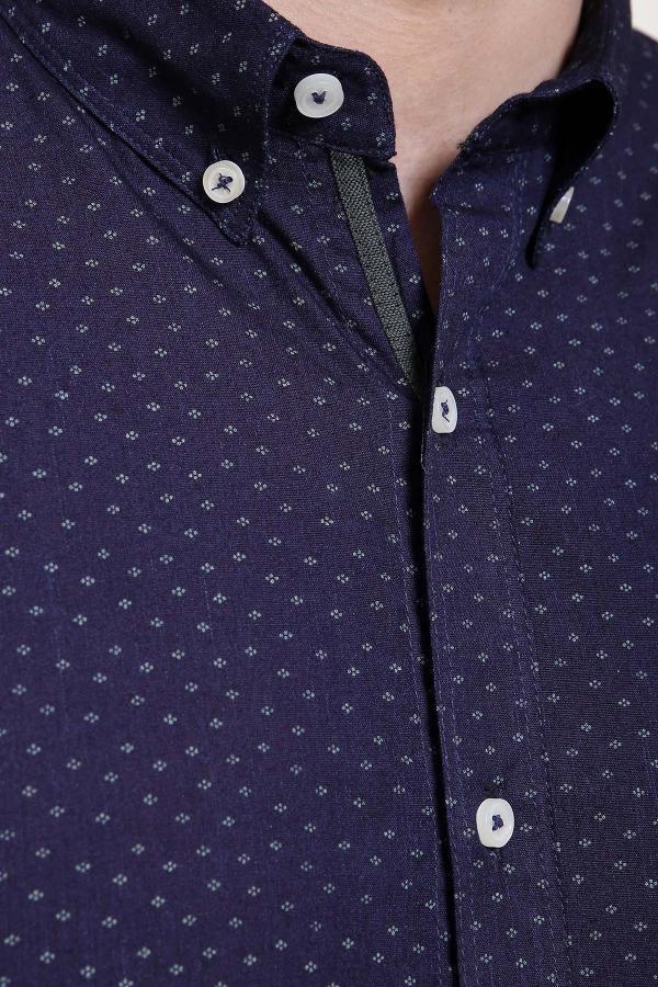 Navy long-sleeve shirt collar close-up with small print and white buttons