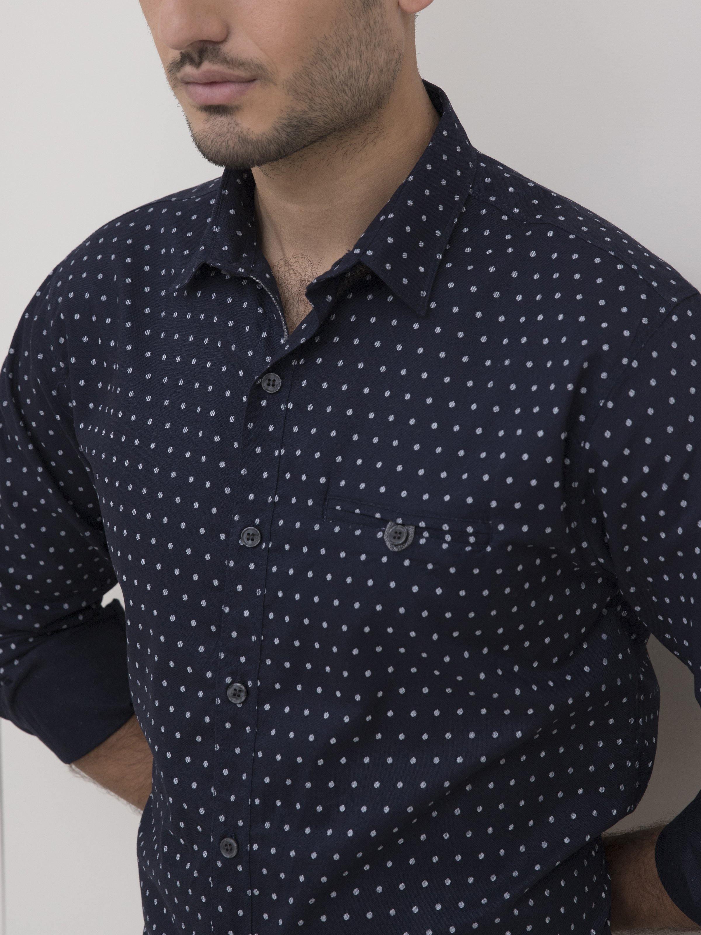 Navy button-up shirt close-up with light dot pattern and button placket