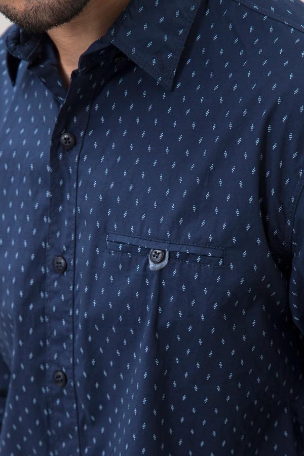 Navy patterned long-sleeve shirt close-up: button placket and chest pocket.