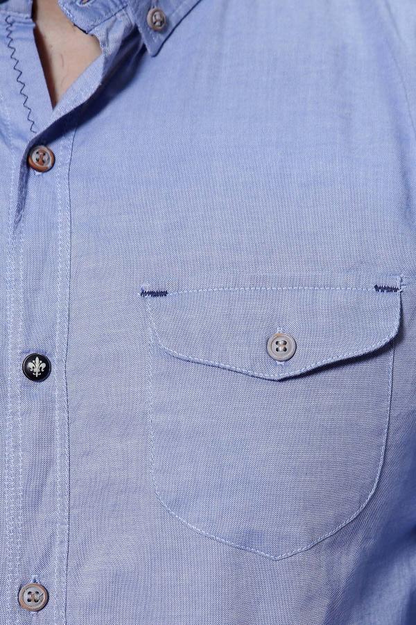 Sky blue long-sleeve shirt closeup: button placket and chest pocket with button