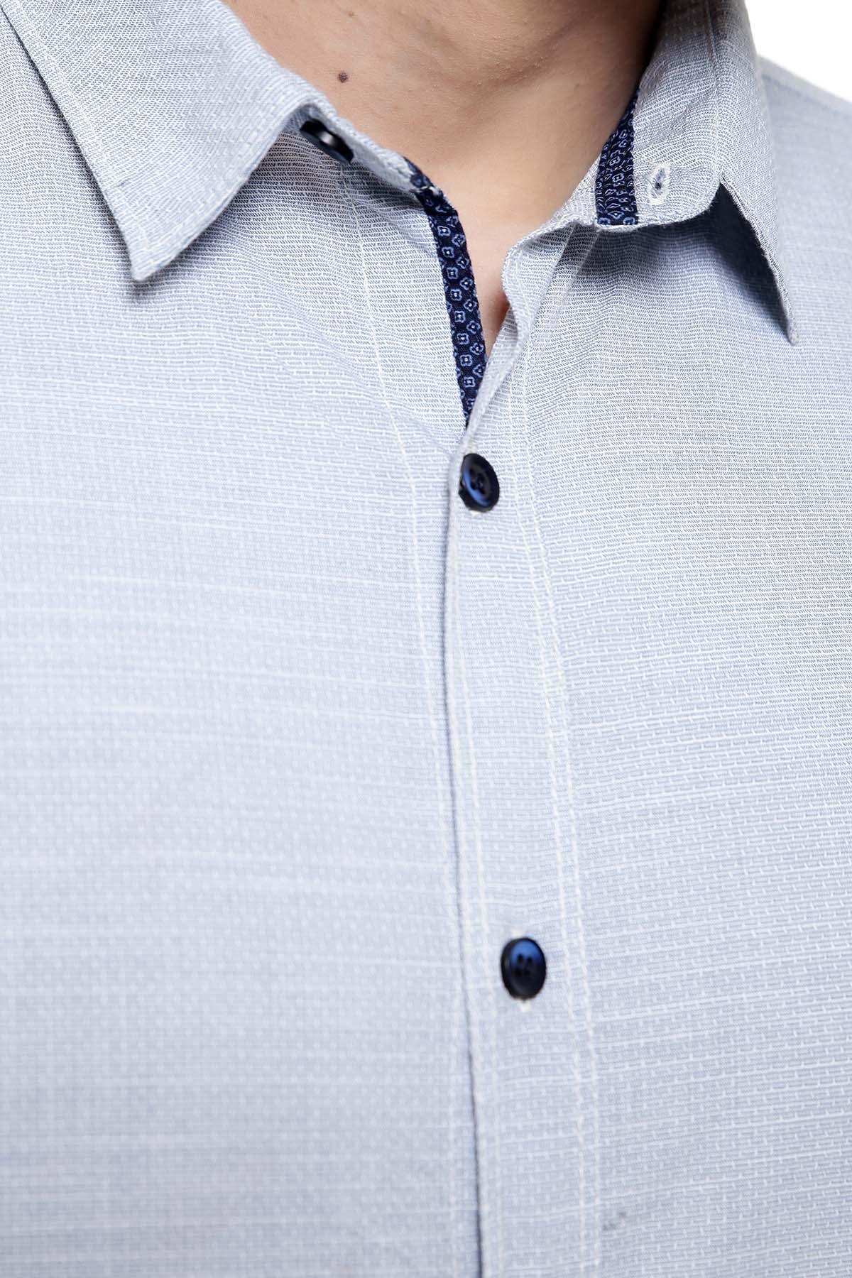 Light blue button-up shirt with pointed collar and dark-trim placket