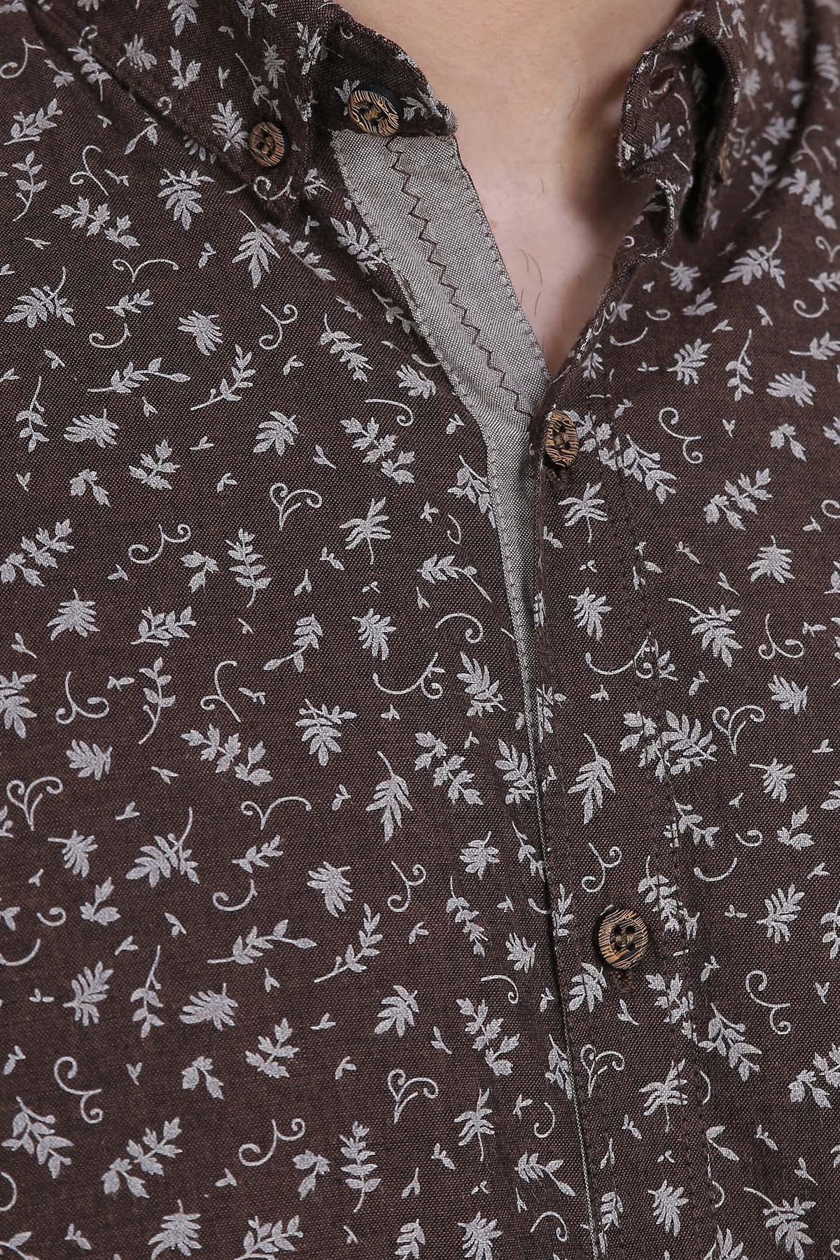 Close-up of brown button placket and full sleeve cuff with white botanical pattern