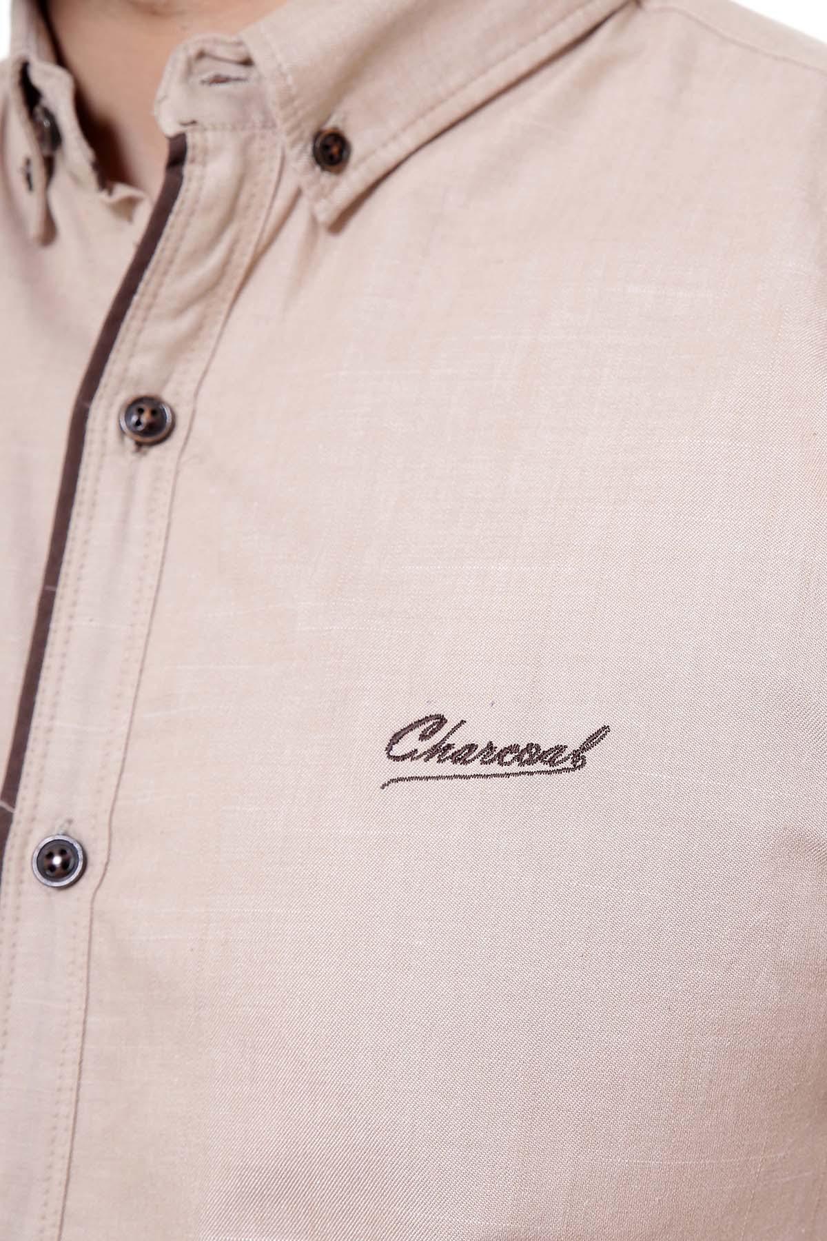 Light brown casual shirt close-up, embroidered logo and button placket