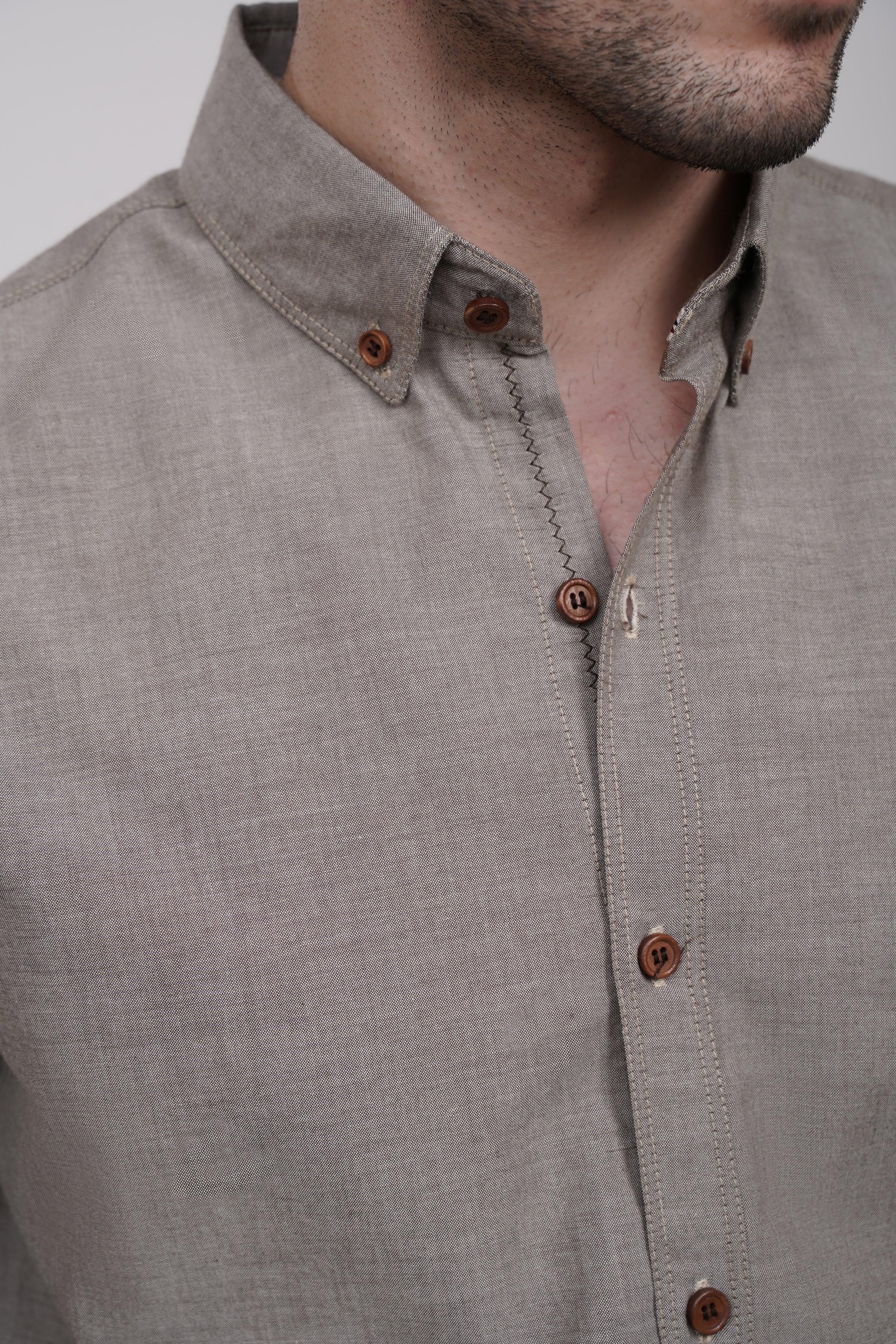 Khaki button-up shirt close-up of stand collar and wooden-style buttons