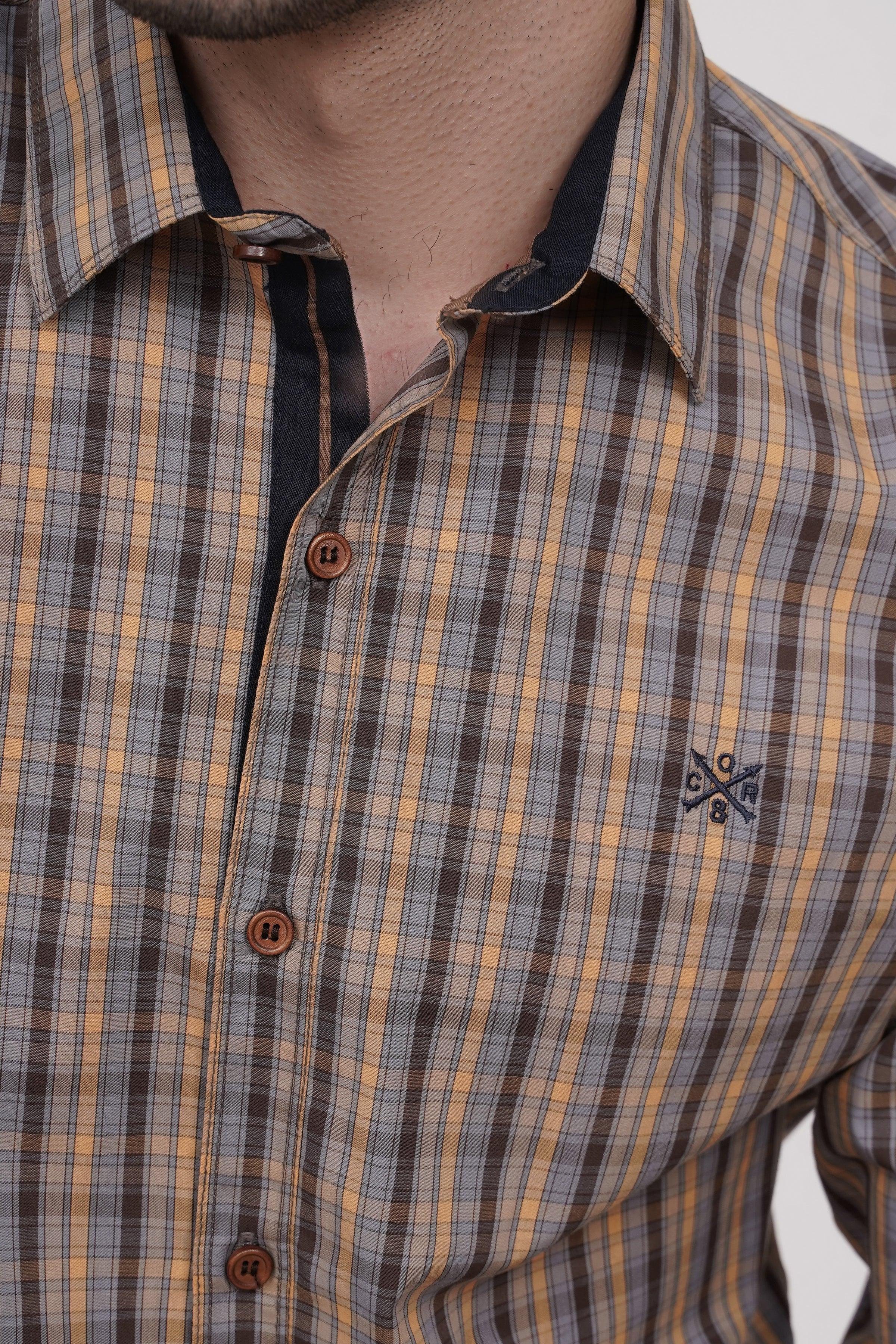 Plaid casual shirt collar and buttons, brown and blue check with chest pocket detail.