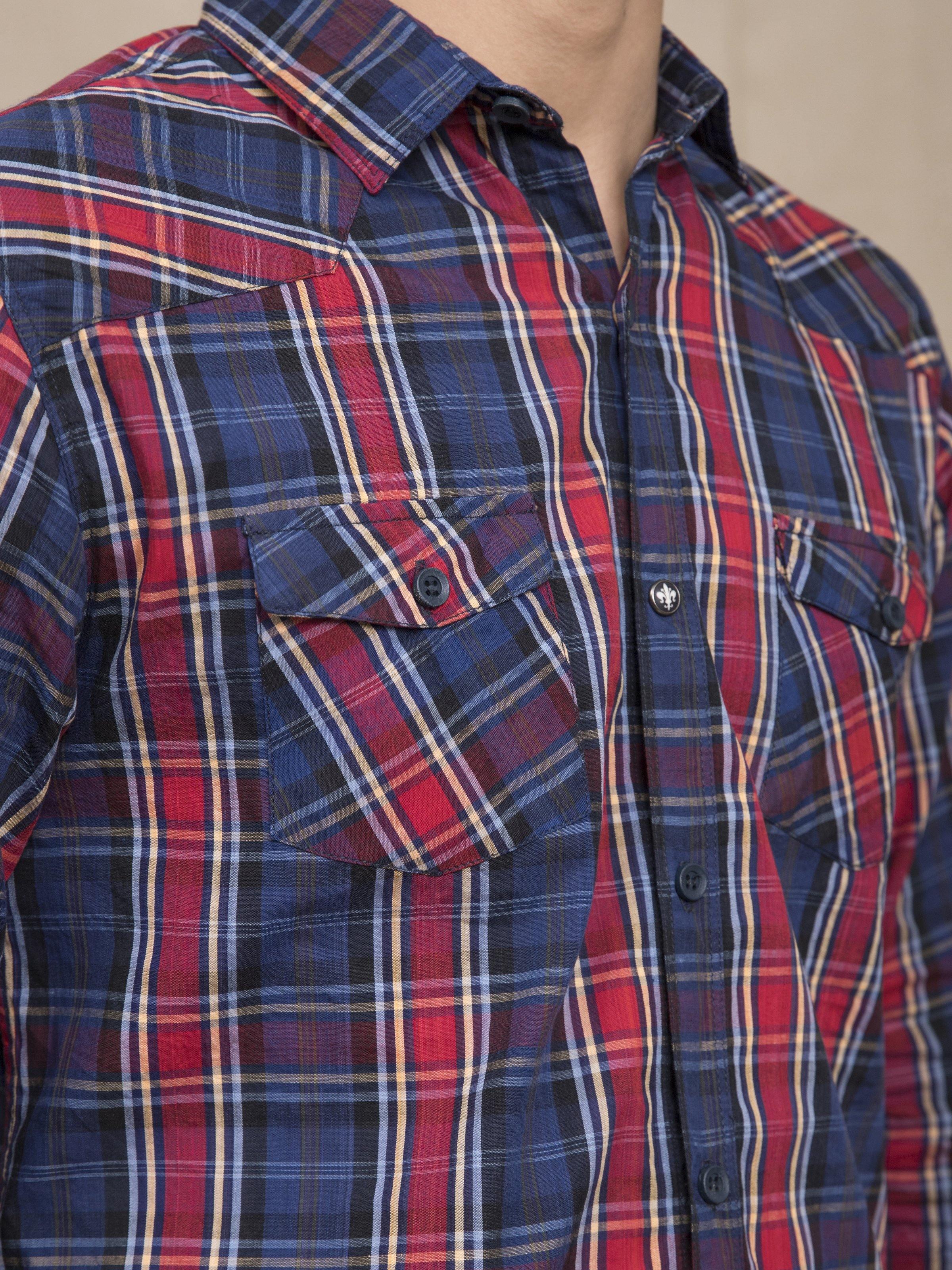 Navy and red plaid button-up shirt close-up of chest pocket and buttons