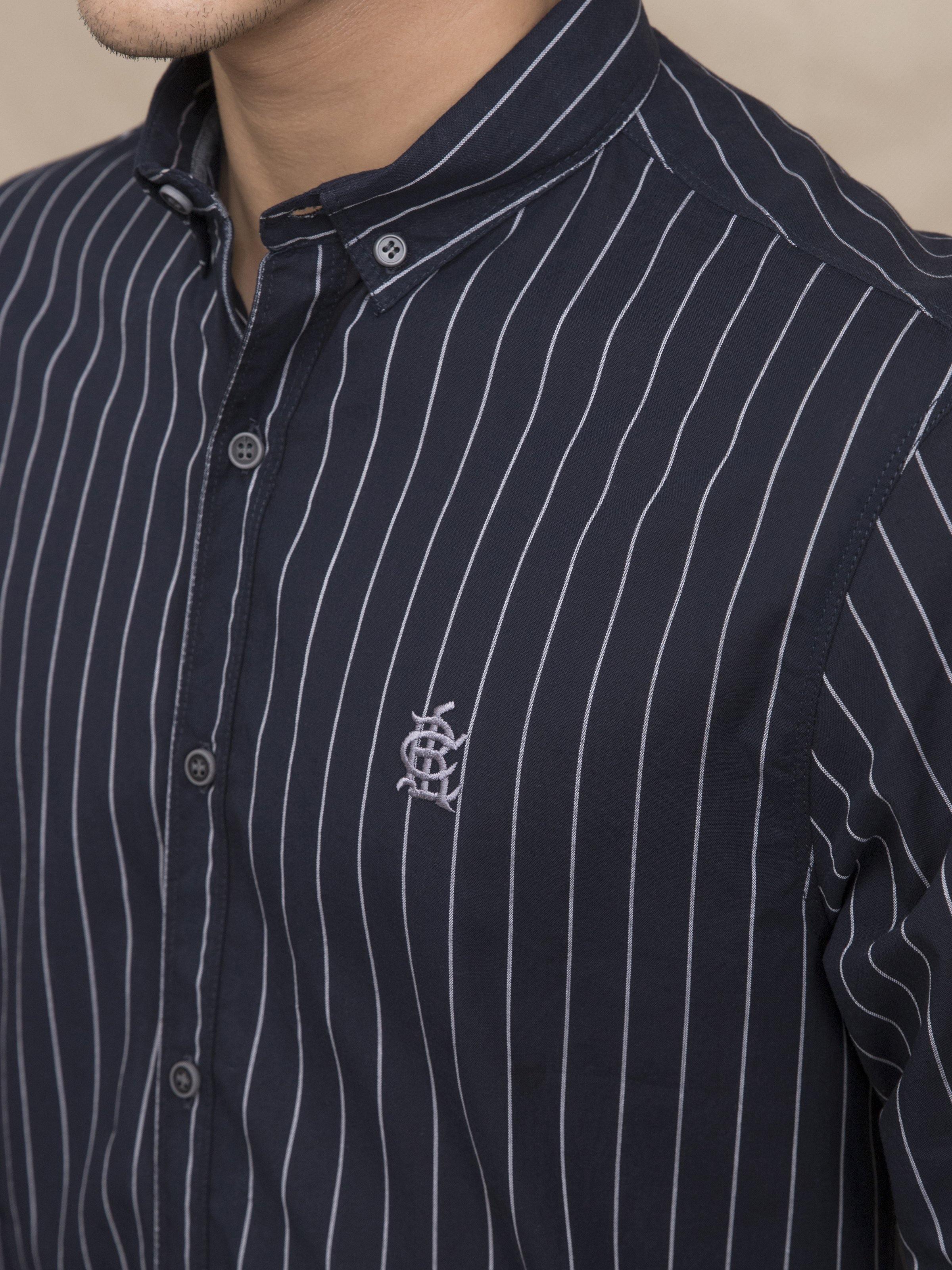 Navy striped shirt close-up: button placket, stand collar, embroidered chest logo