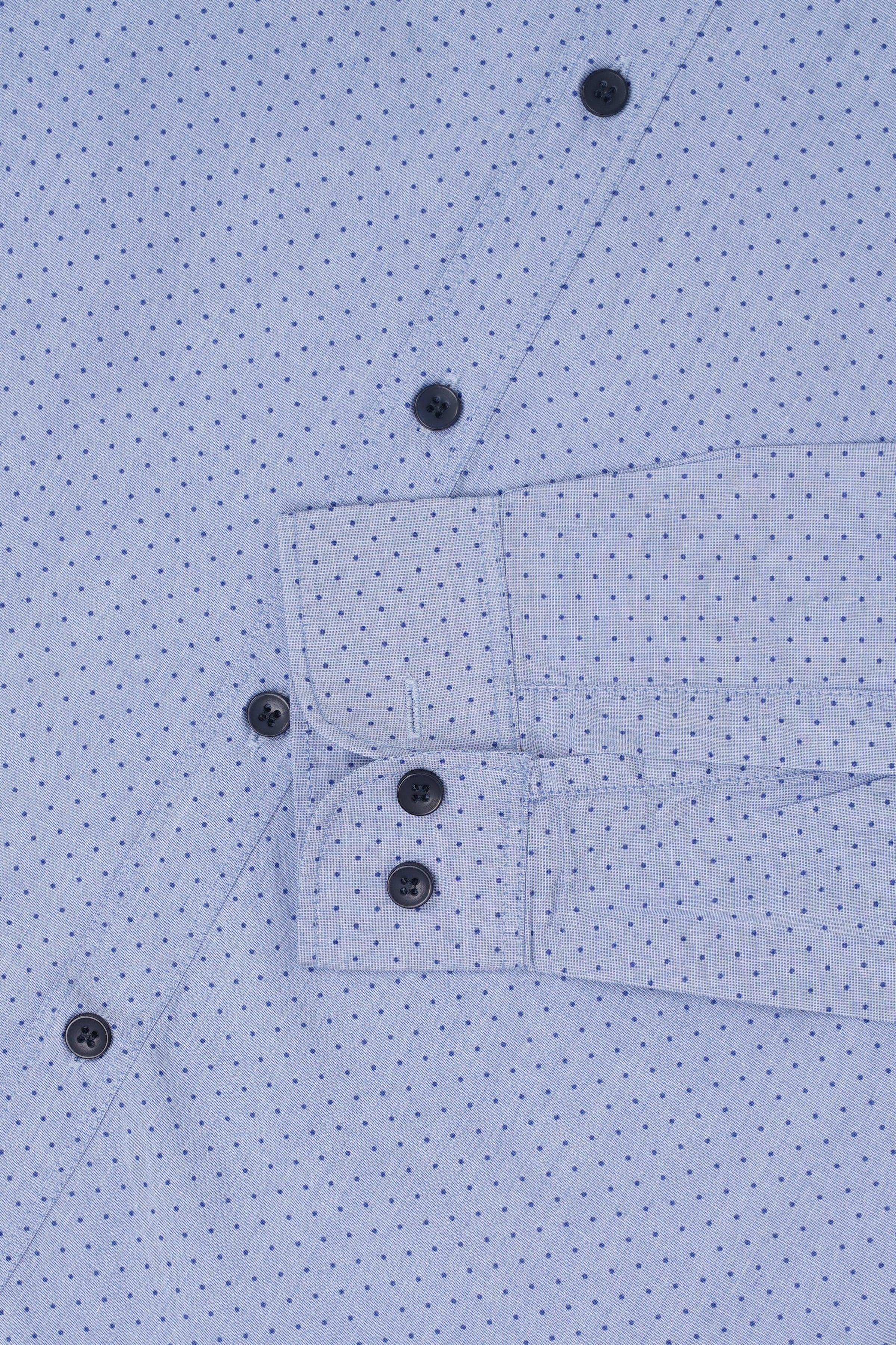 Men's light blue dotted button-up shirt, view of placket and cuff with dark buttons