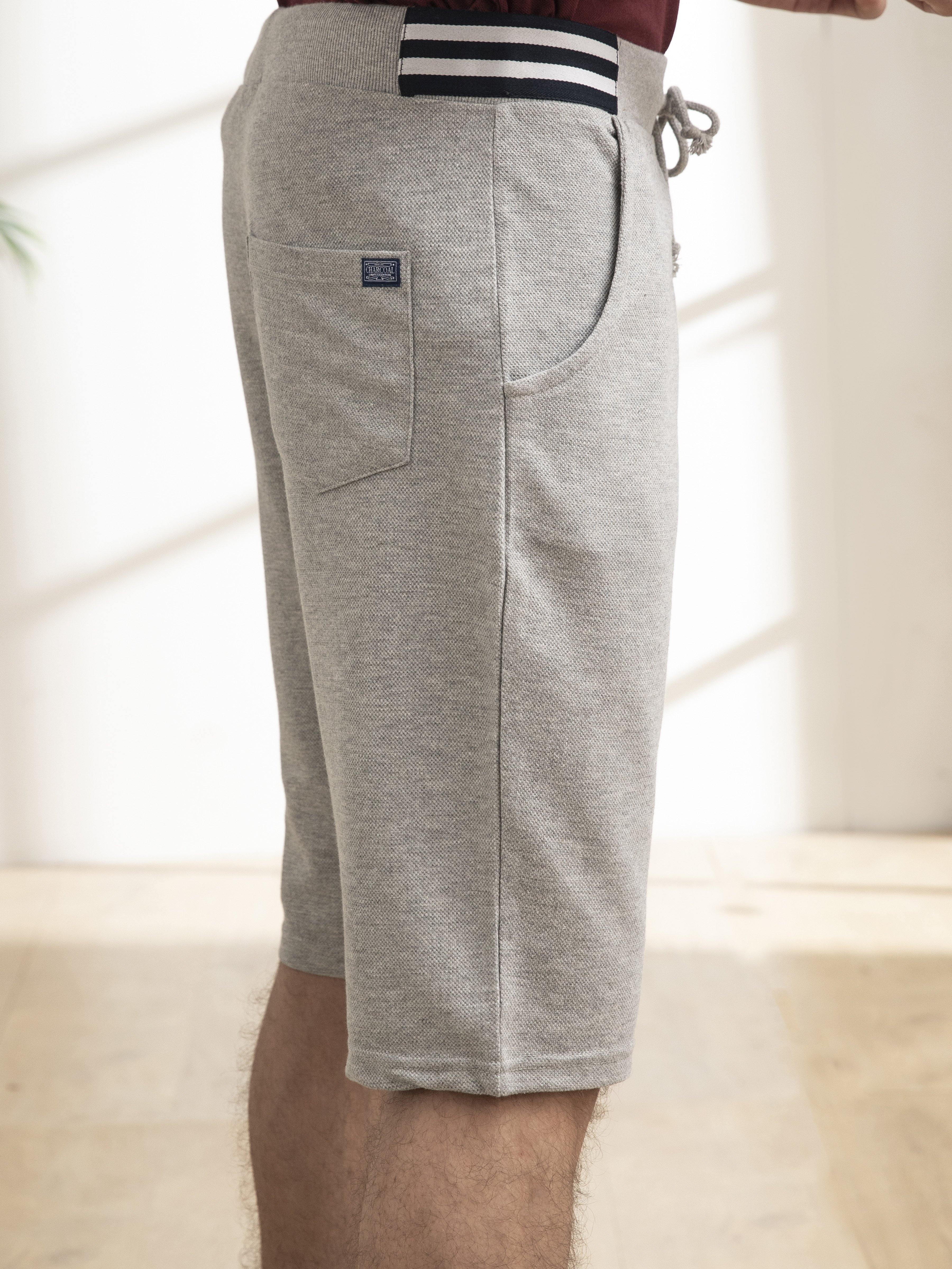 Grey melange casual shorts with drawstring waistband, back pocket and logo patch