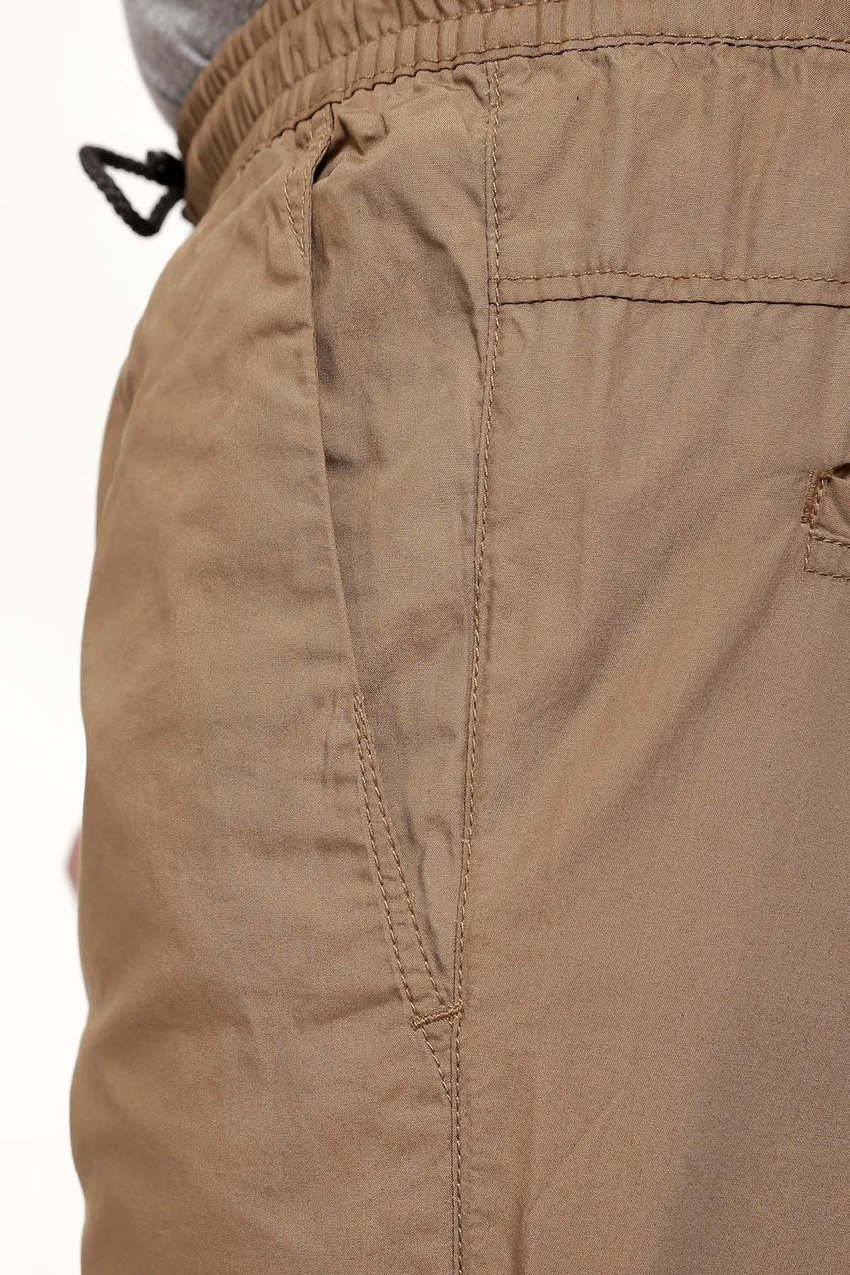 Dark khaki trouser pocket and stitched panel with drawstring waist